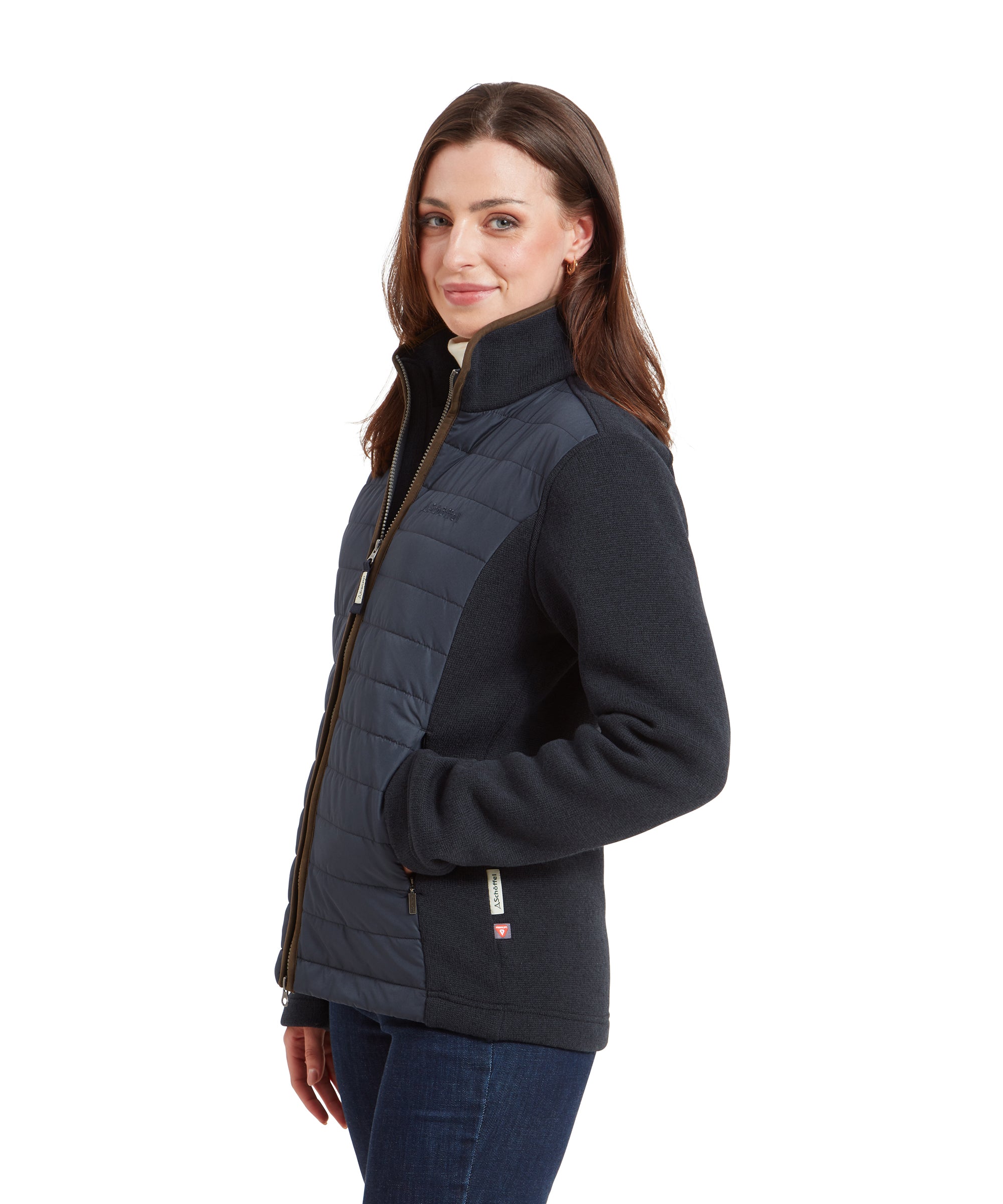 Woman wearing a Schöffel Burley Hybrid Jacket for Women in Blue with quilted front panels, facing slightly to the right with a relaxed expression.