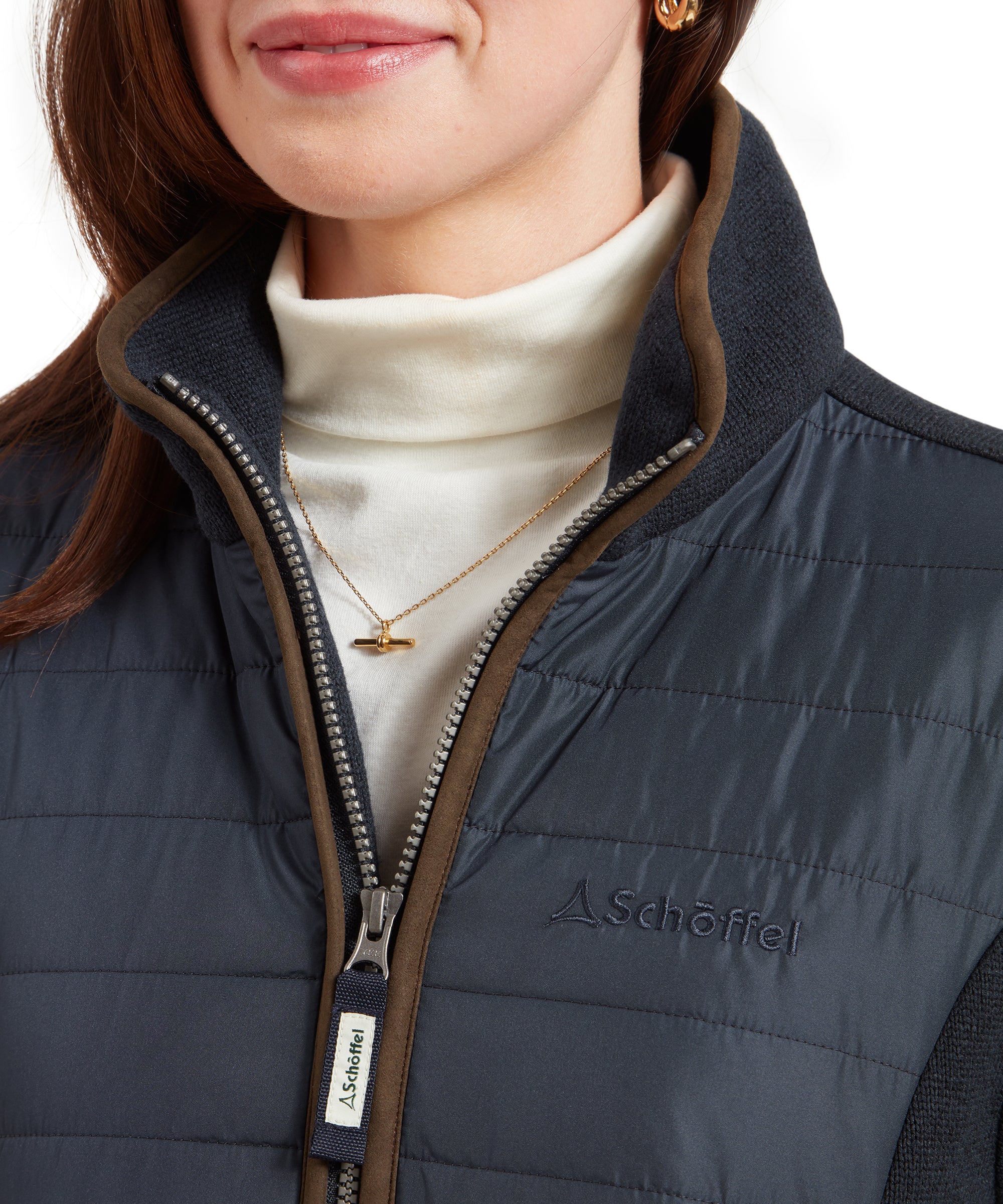 Close-up of the front zipper of the Schöffel Burley Hybrid Jacket for Women in Blue, with Schöffel branding on the zipper pull.