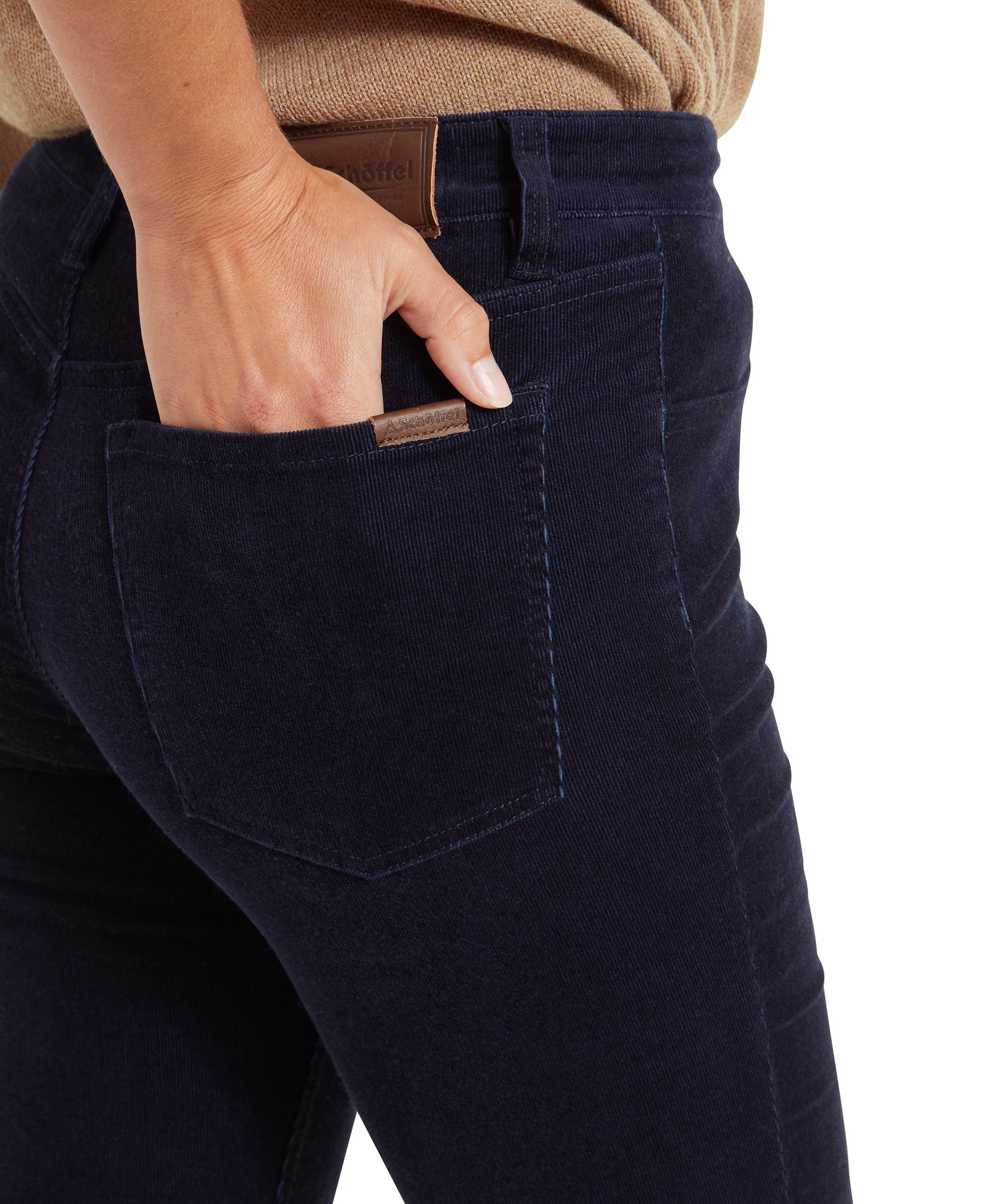 A close-up of a woman’s hand resting in the back pocket of Schöffel Clover Cord Jean for Womens in Navy, showing the texture and colour of the fabric.