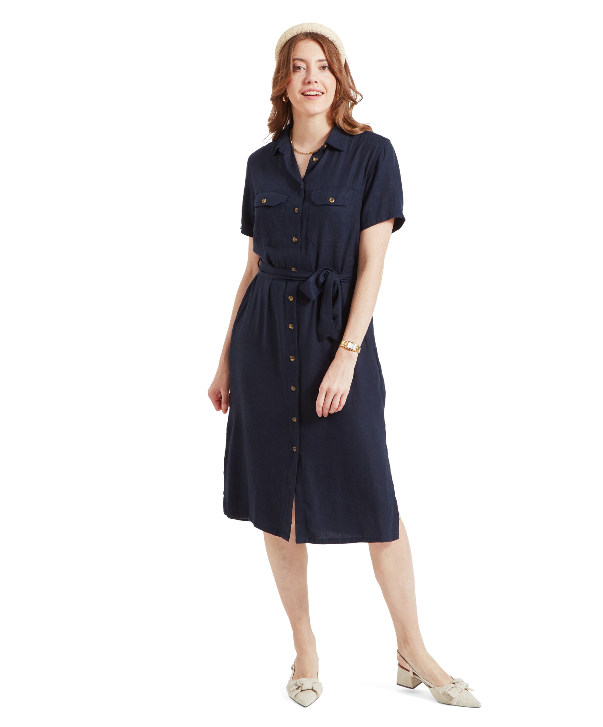 Woman in Schöffel Daisy Linen Dress for Women in Navy with short sleeves and a waist tie, smiling and standing with her hands at her sides.