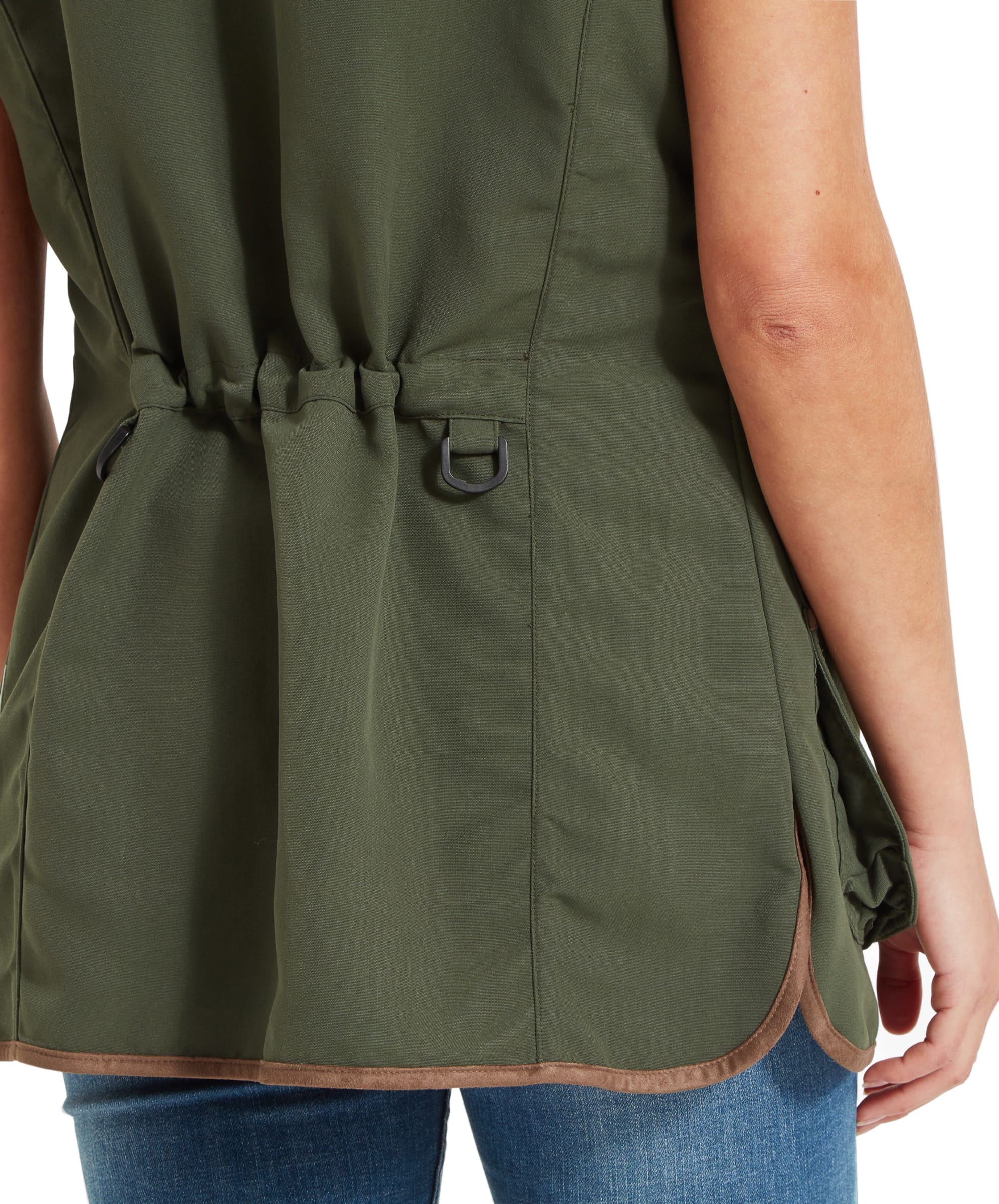 A close-up view of the back of a Schöffel Edenham Clay Shooting Vest for Women in Green worn by a woman. The focus is on the drawstring waist and D-rings on the sides of the vest, providing a detailed look at the back design.