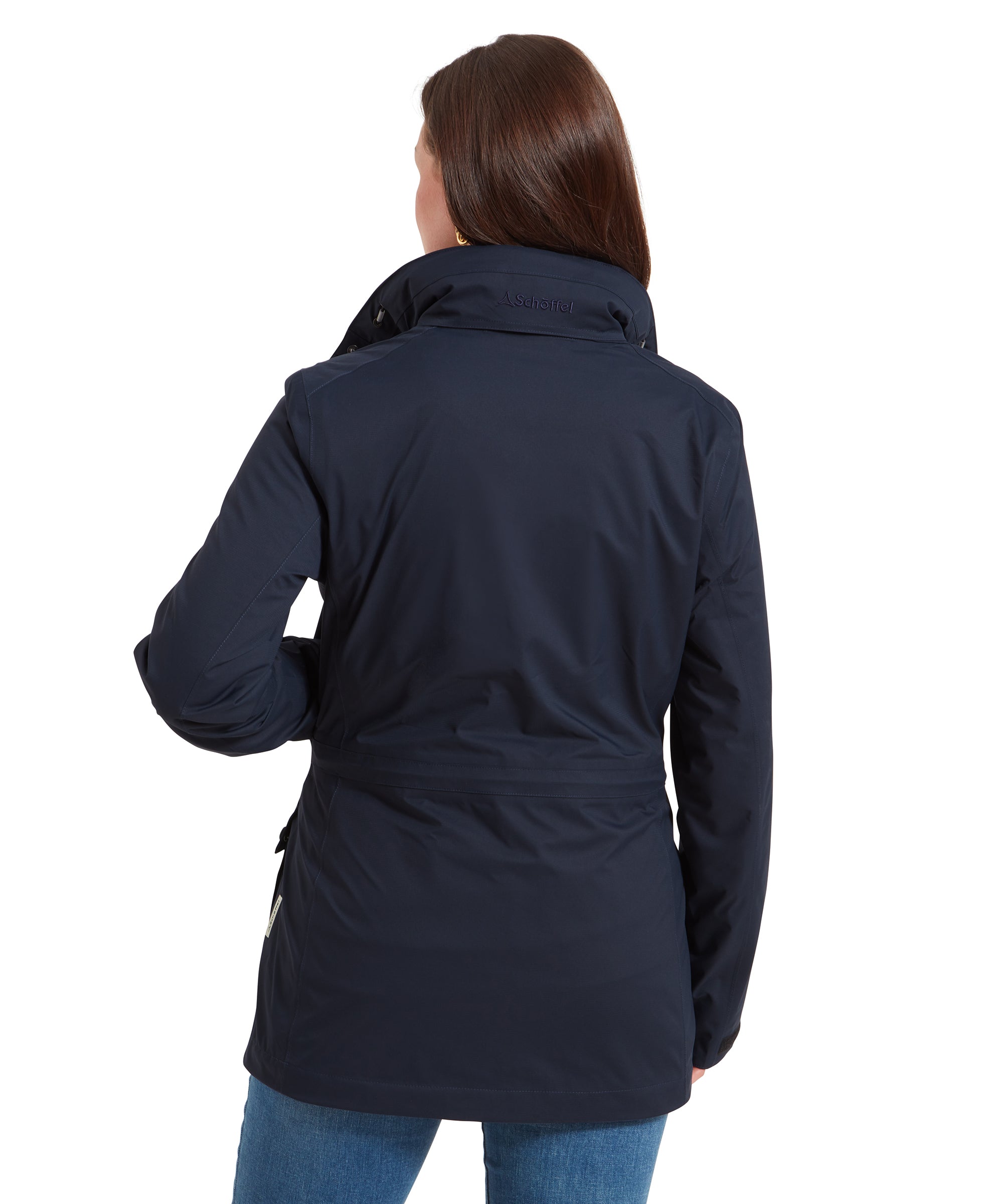 A rear view of a woman wearing a Schöffel Edith Jacket for Women in Blue, showing the fitted waist and the back details, including the slightly raised collar.