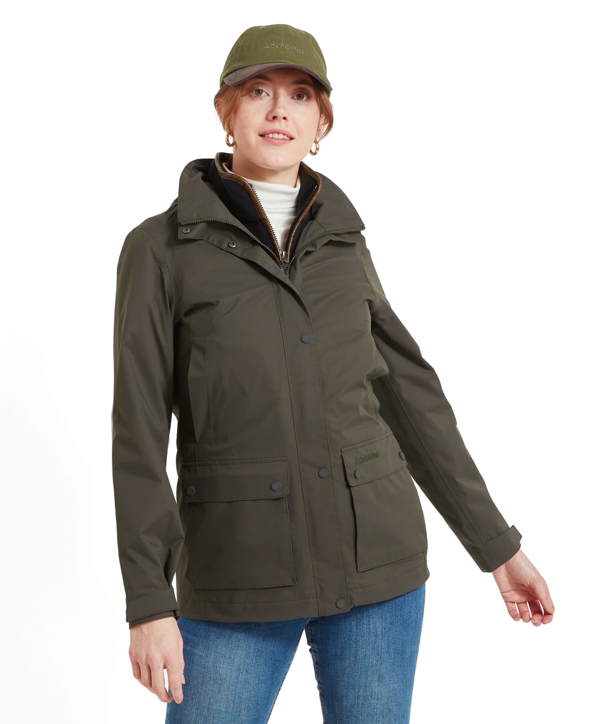 Woman wearing an Schöffel Edith Jacket for Women in Green with a stand-up collar, front pockets, and a hidden zipper. The jacket has a clean, functional design with a fitted look.