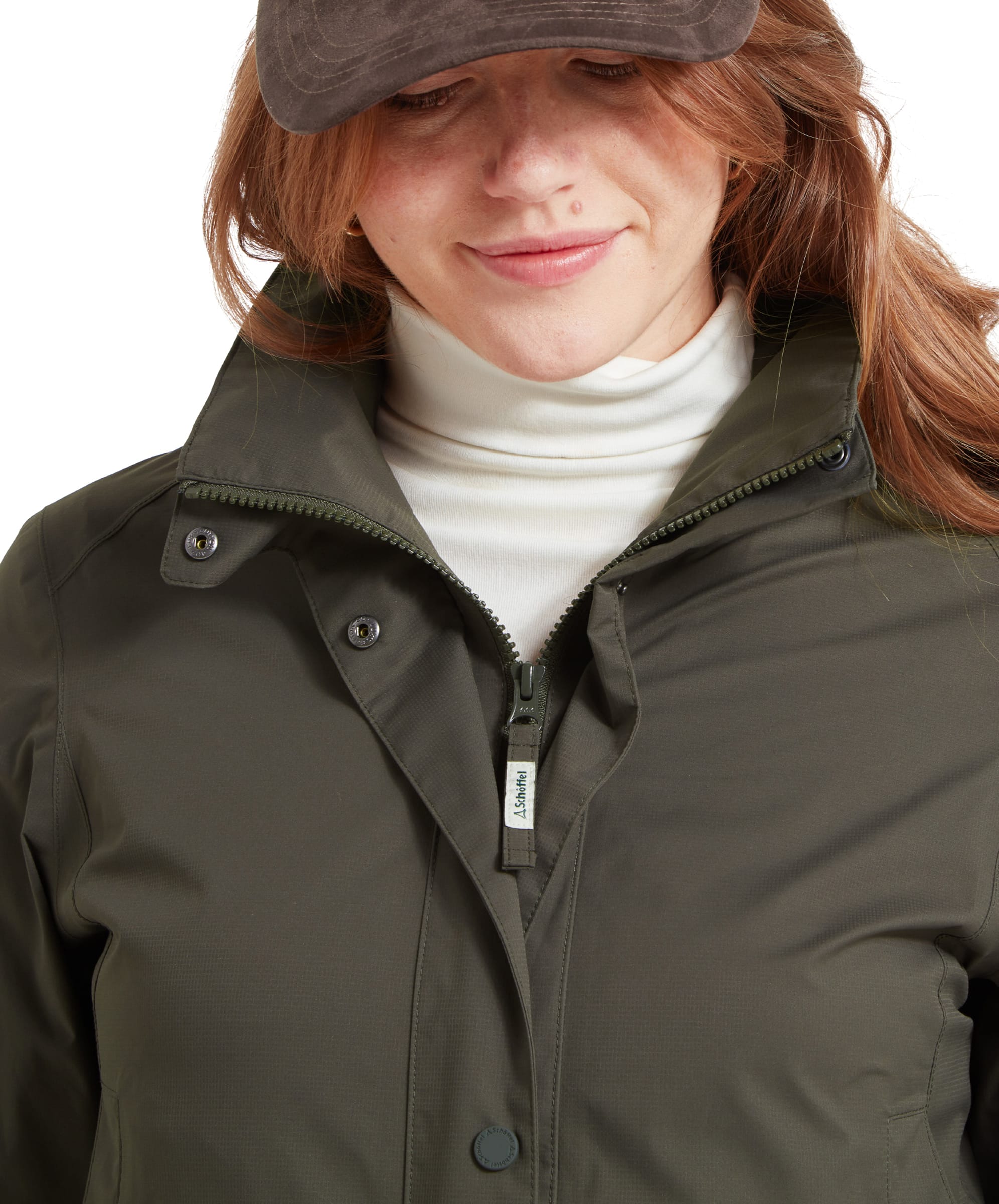 Close-up shot of a woman’s face and the collar area of an Schöffel Edith Jacket for Women in Green, highlighting the collar and top zipper detail.