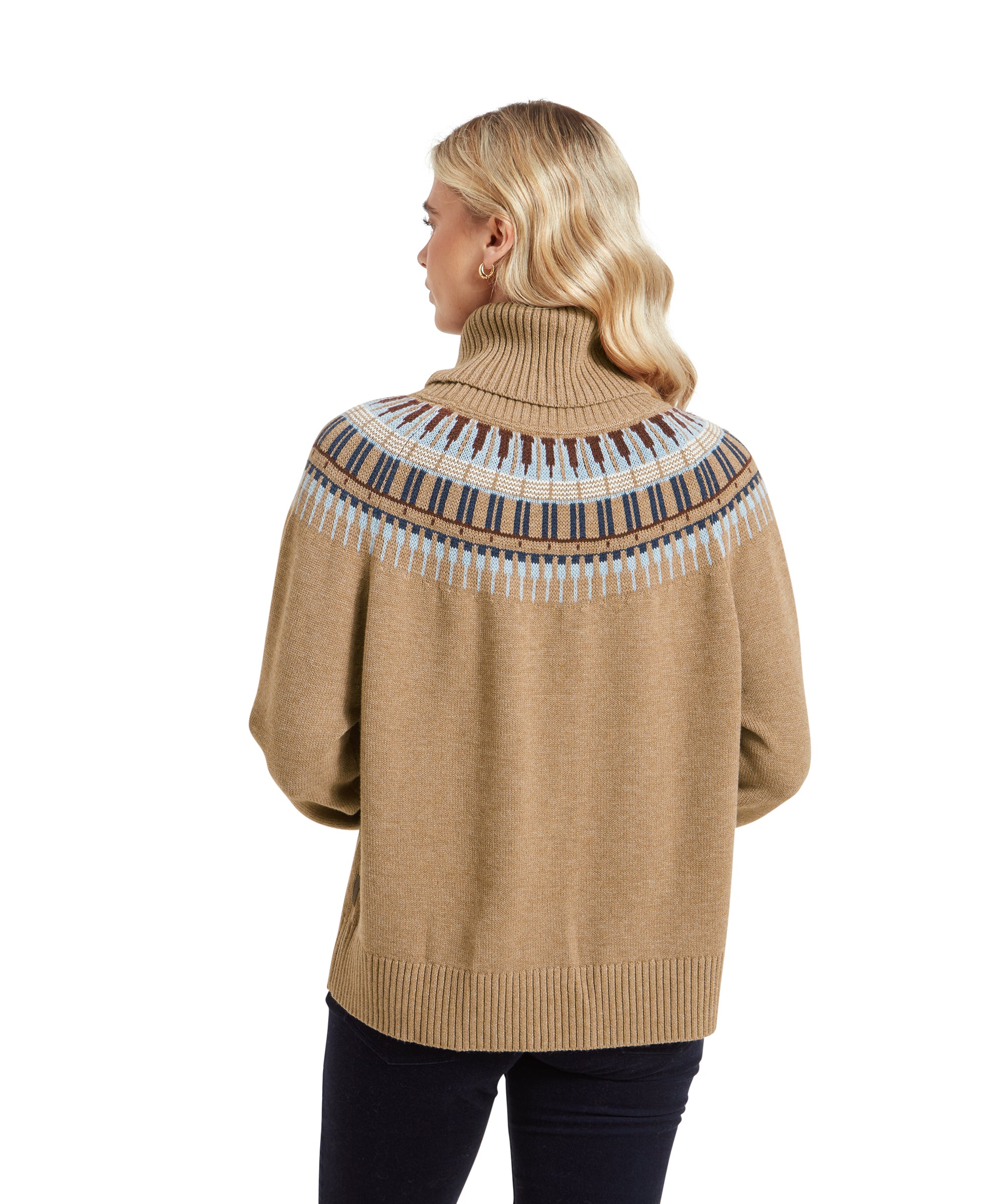 A rear view of the woman wearing the Schöffel Filey Fairisle Roll Neck Jumper for Women in Beige. The detailed pattern on the upper back is visible, and the jumper's slightly loose fit is highlighted as it drapes over her back.