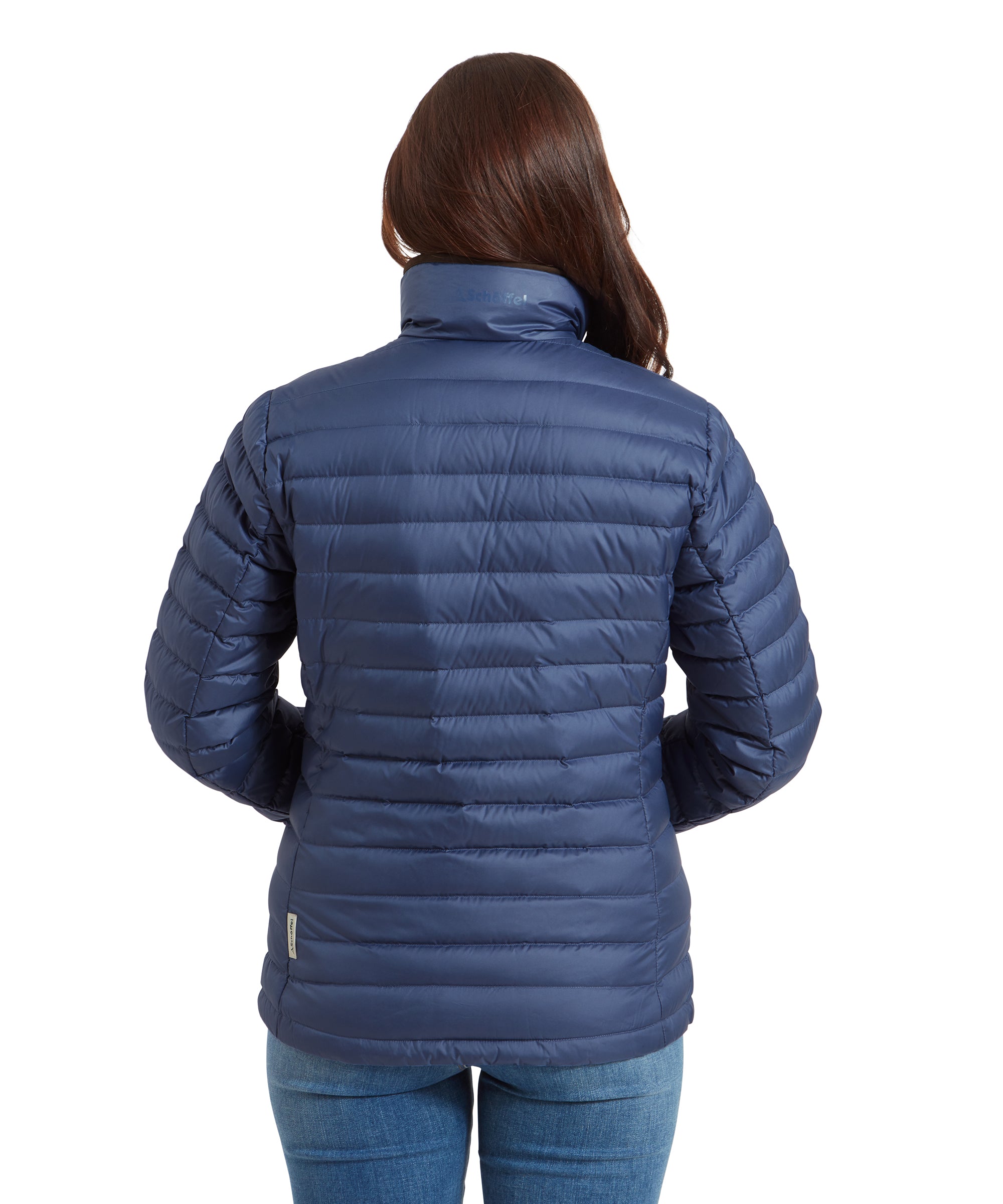 Back view of a woman wearing a Schöffel Hambleton Down Jacket for Women in Blue. The back of the collar features the “Schöffel” logo.