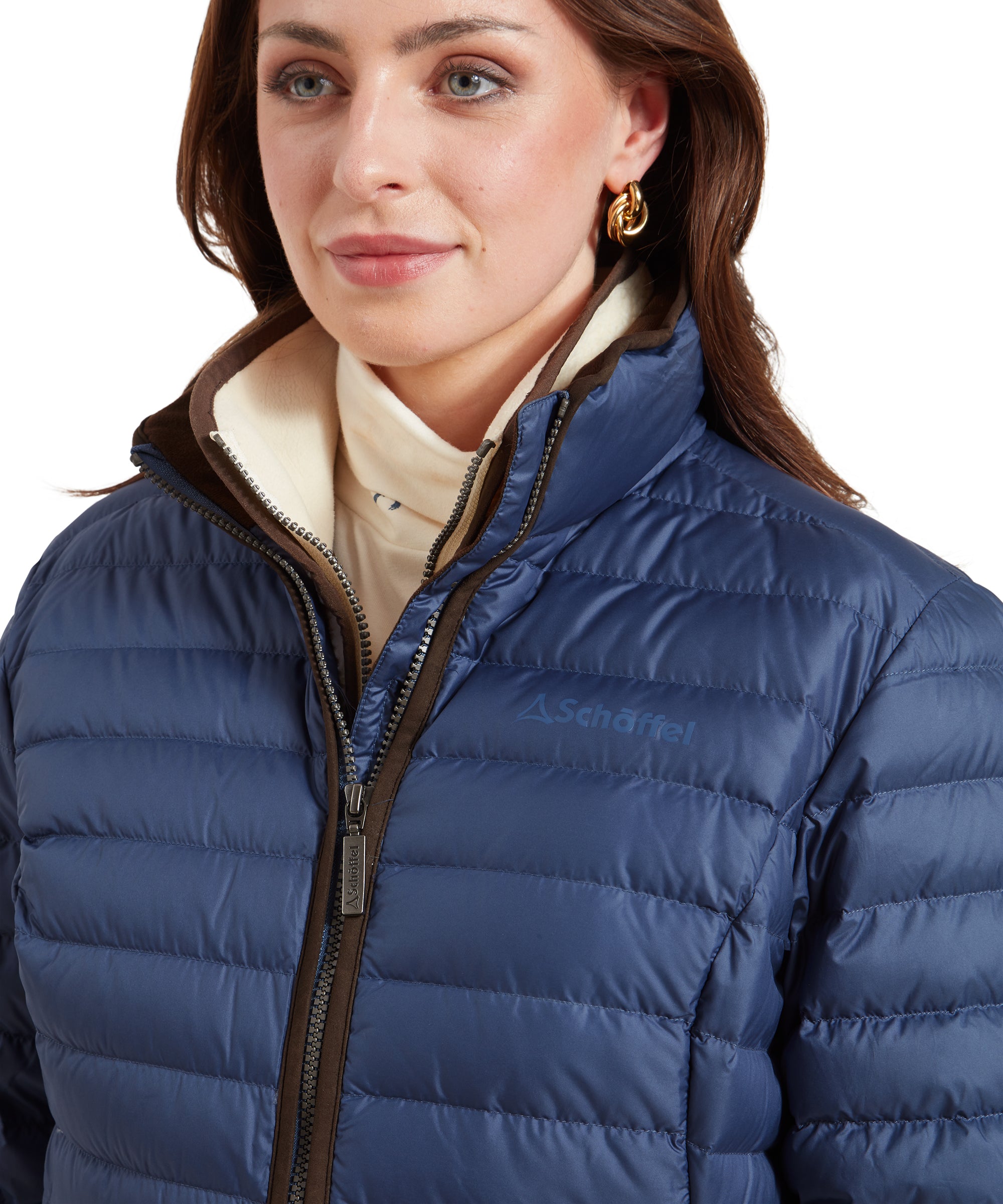 Close-up of the collar of a Schöffel Hambleton Down Jacket for Women in Blue with the “Schöffel” logo on the back.