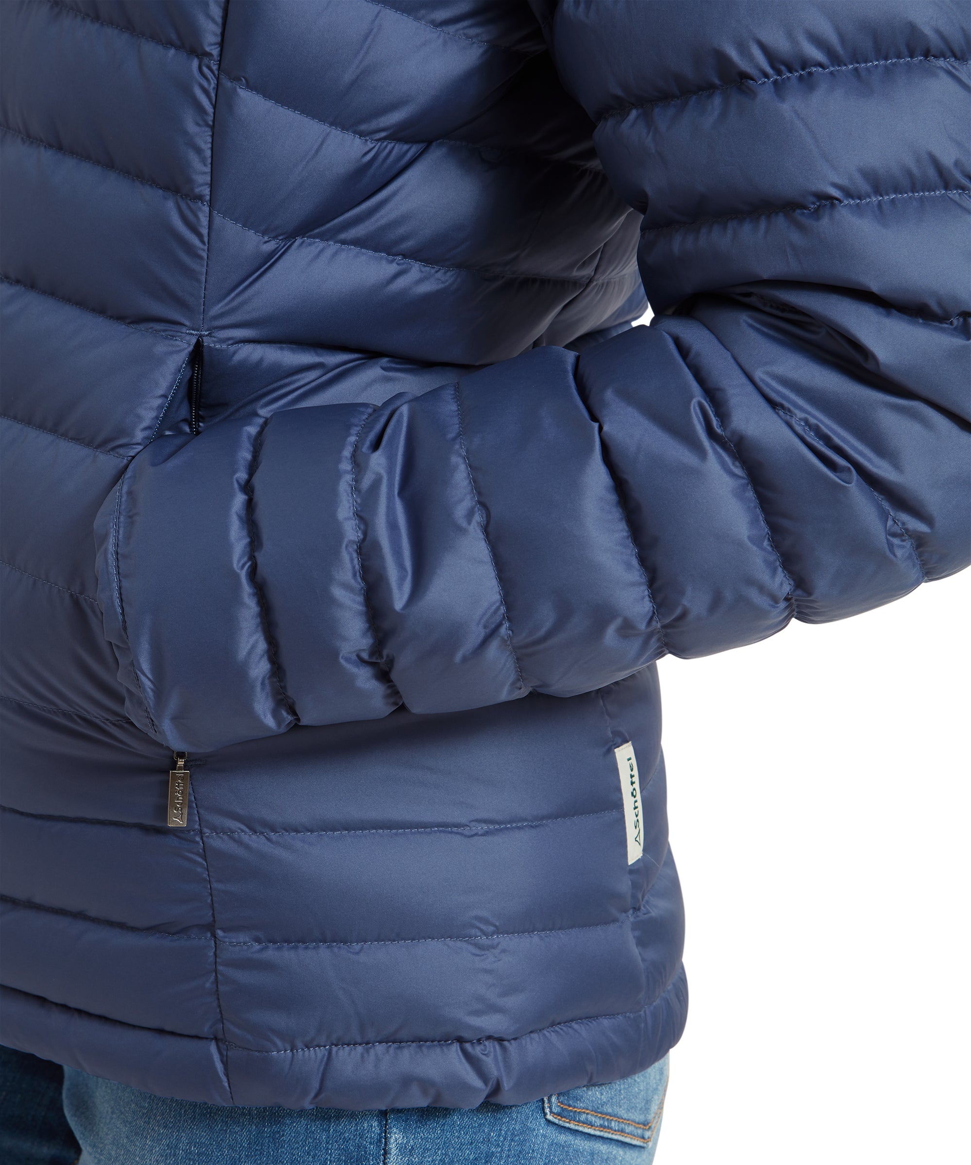 Close-up of the pocket area of a Schöffel Hambleton Down Jacket for Women in Blue, showing the stitching detail and a small logo tag on the side.