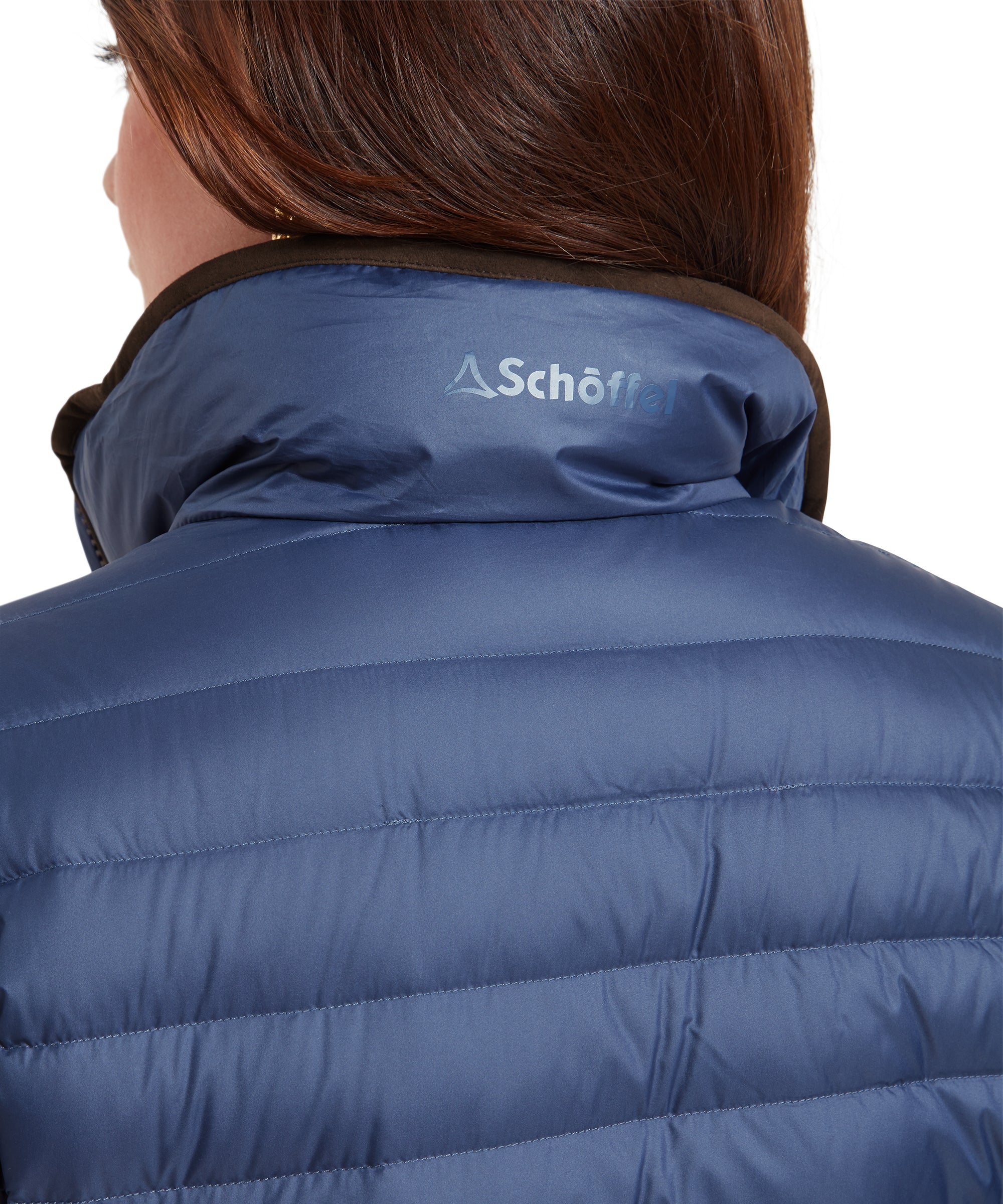 Close-up of the front zipper of a Schöffel Hambleton Down Jacket for Women in Blue, focusing on the zipper pull, which has the "Schöffel" logo.