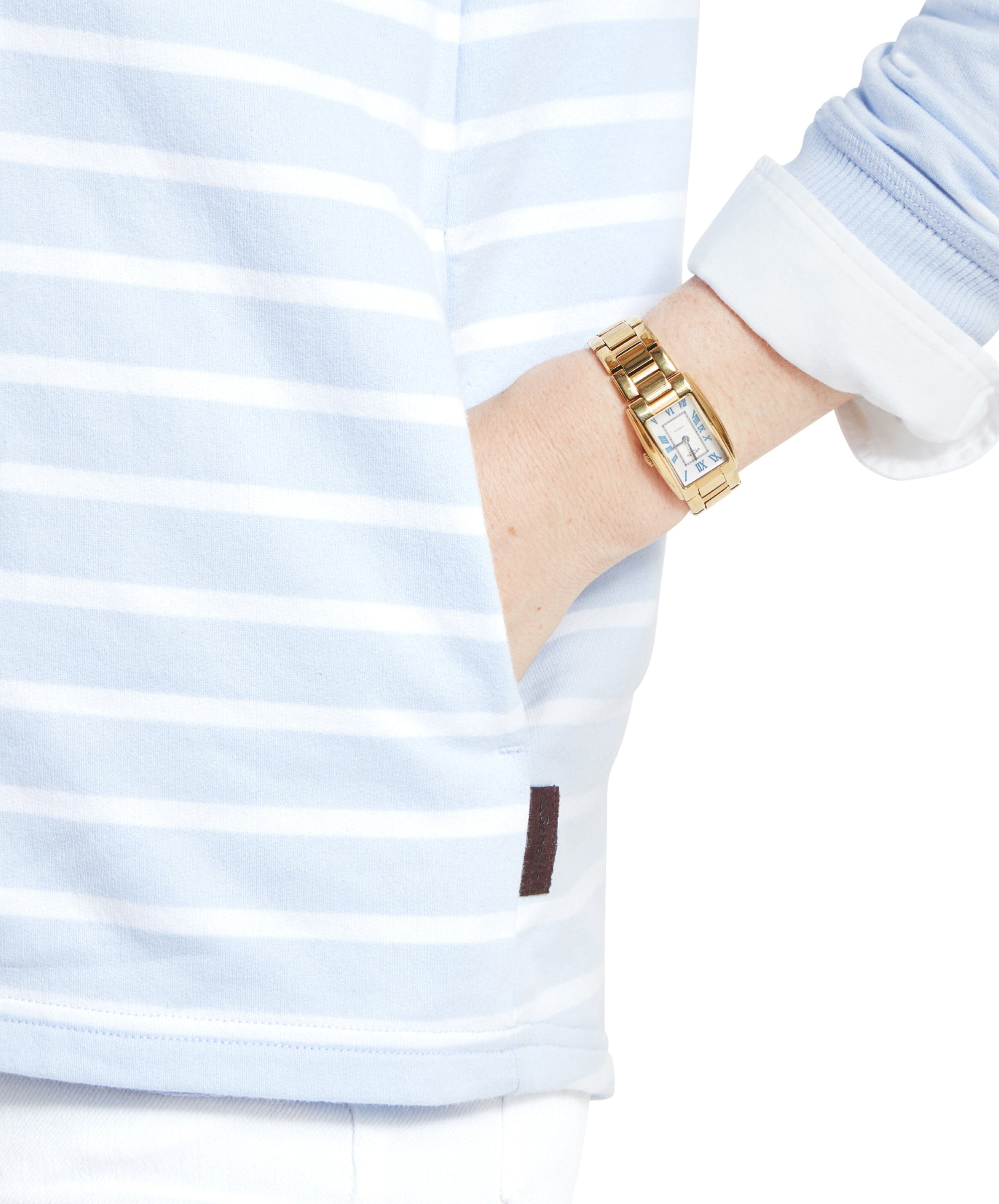 A close-up image of a woman wearing a Schöffel Hope Cove Sweatshirt for Women in Blue, highlighting the sleeve and a gold wristwatch, with a white background.