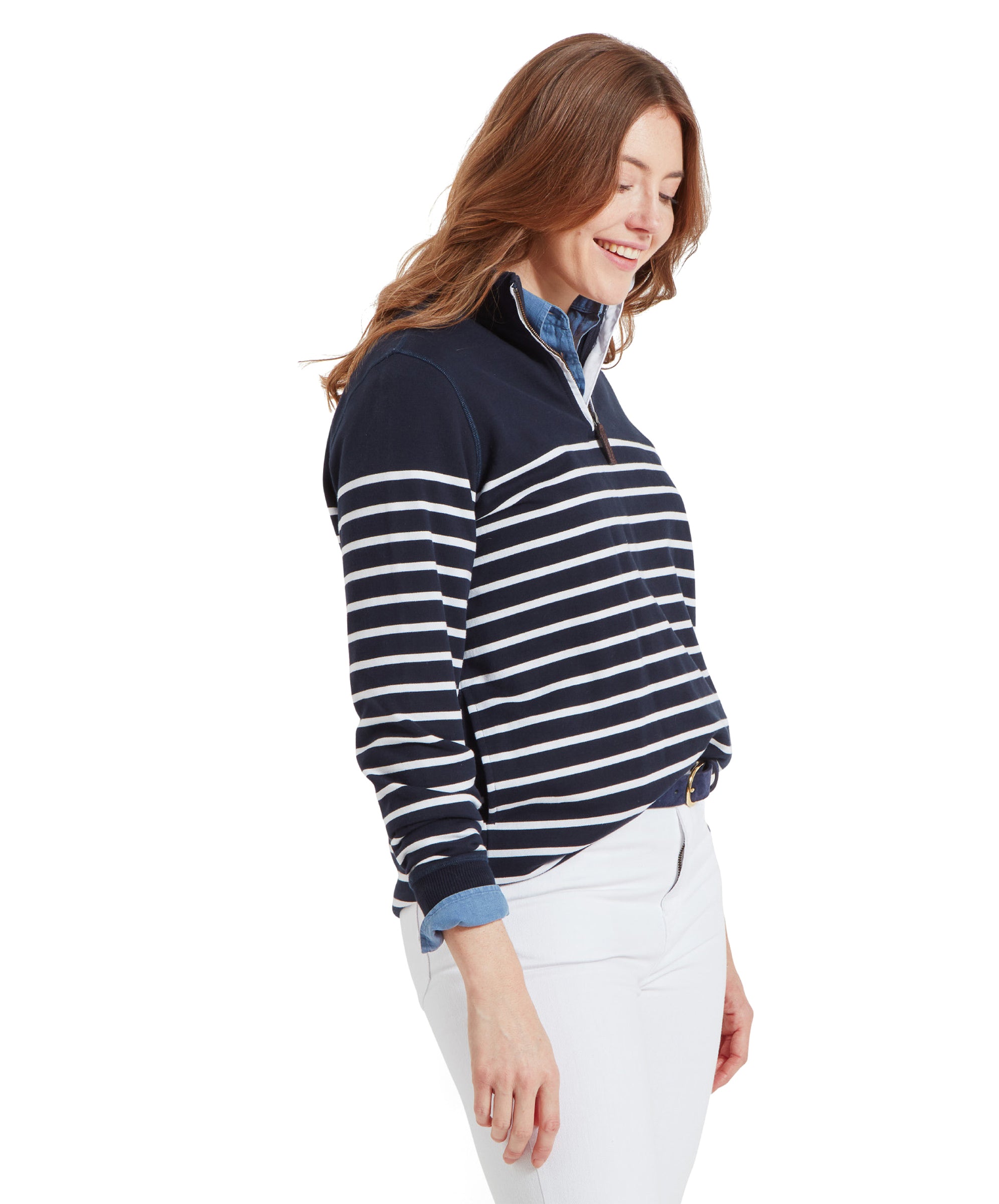 Side view of a woman in a Schöffel Hope Cove Sweatshirt for Women in Navy and white jeans, smiling and looking down.