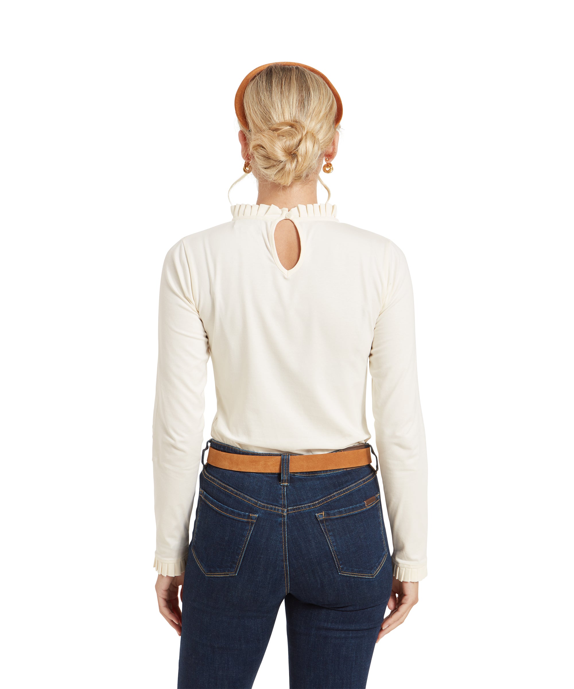 Back view of the same woman wearing the Schöffel Ilkley Top for Women in Cream. The top features a small keyhole cutout at the back of the neckline with a button closure. Her hair is styled in a low bun.