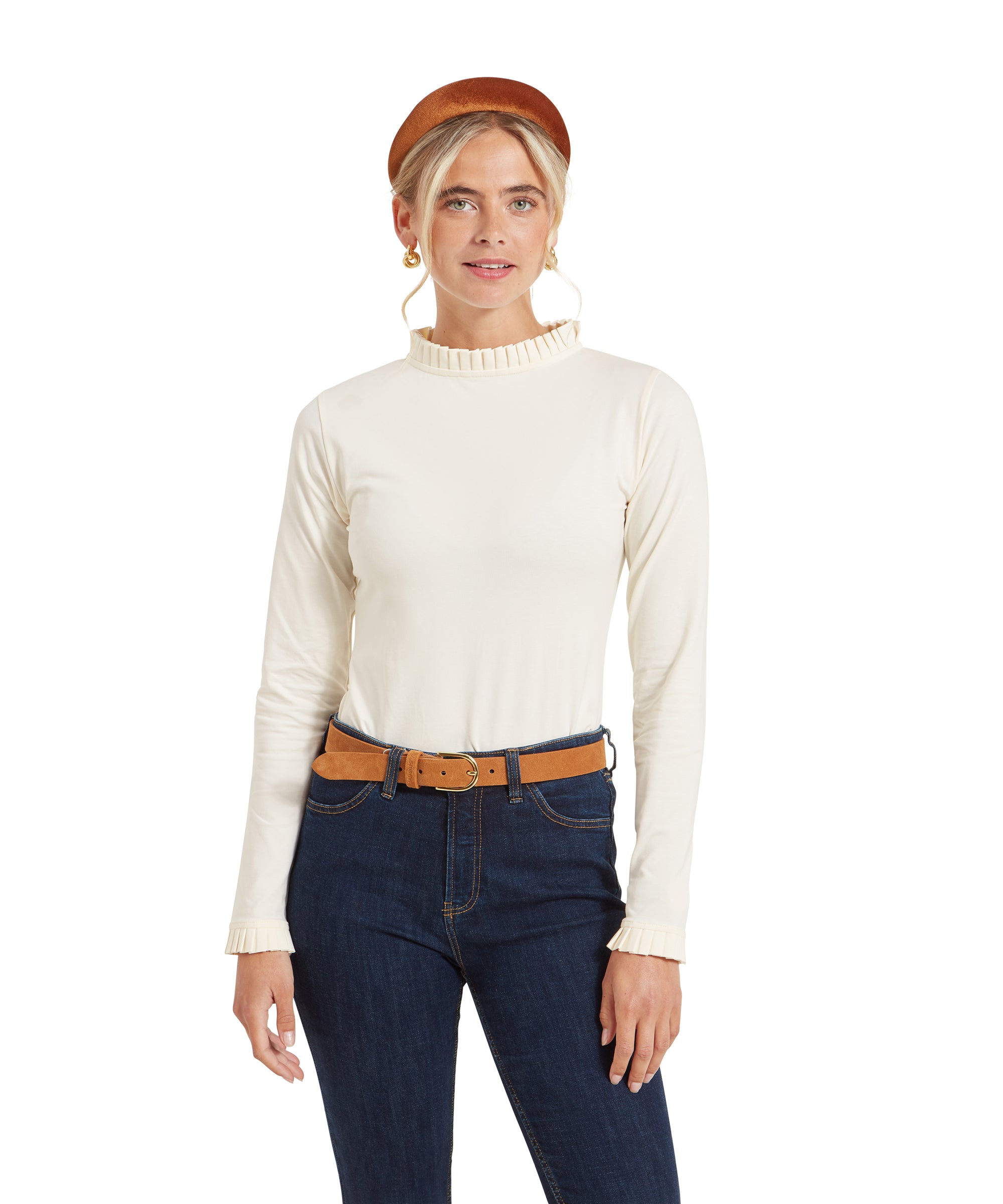 Front view of the woman wearing the Schöffel Ilkley Top for Women in Cream. She is standing straight with her arms relaxed by her sides. The pleated neckline and cuffs are clearly visible.