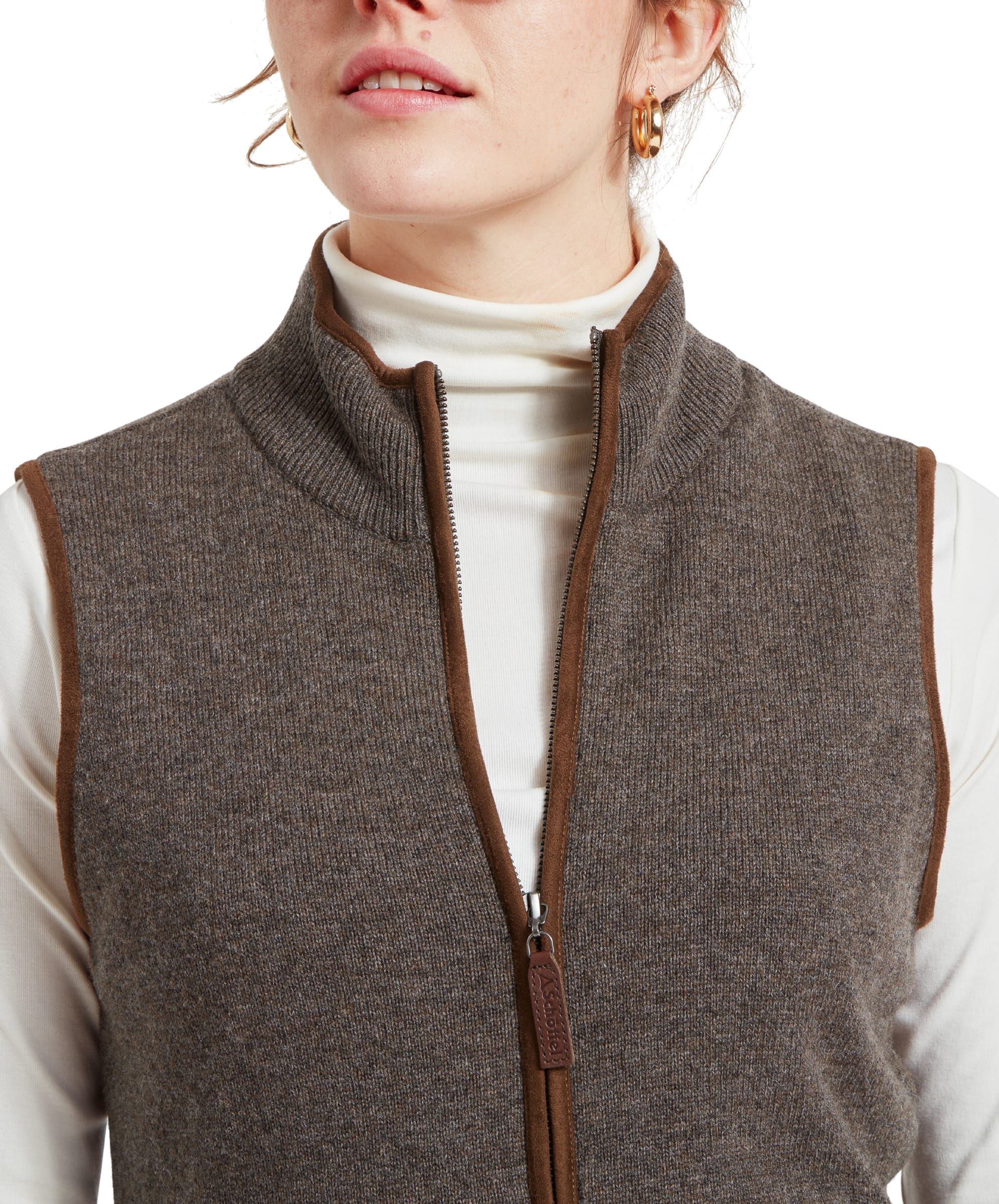 Close-up of the collar area of the Schöffel Women's Lambswool Aerobloc Gilet for Womens in Brown, showing the detailed texture of the fabric and the zipper with a leather pull tab.