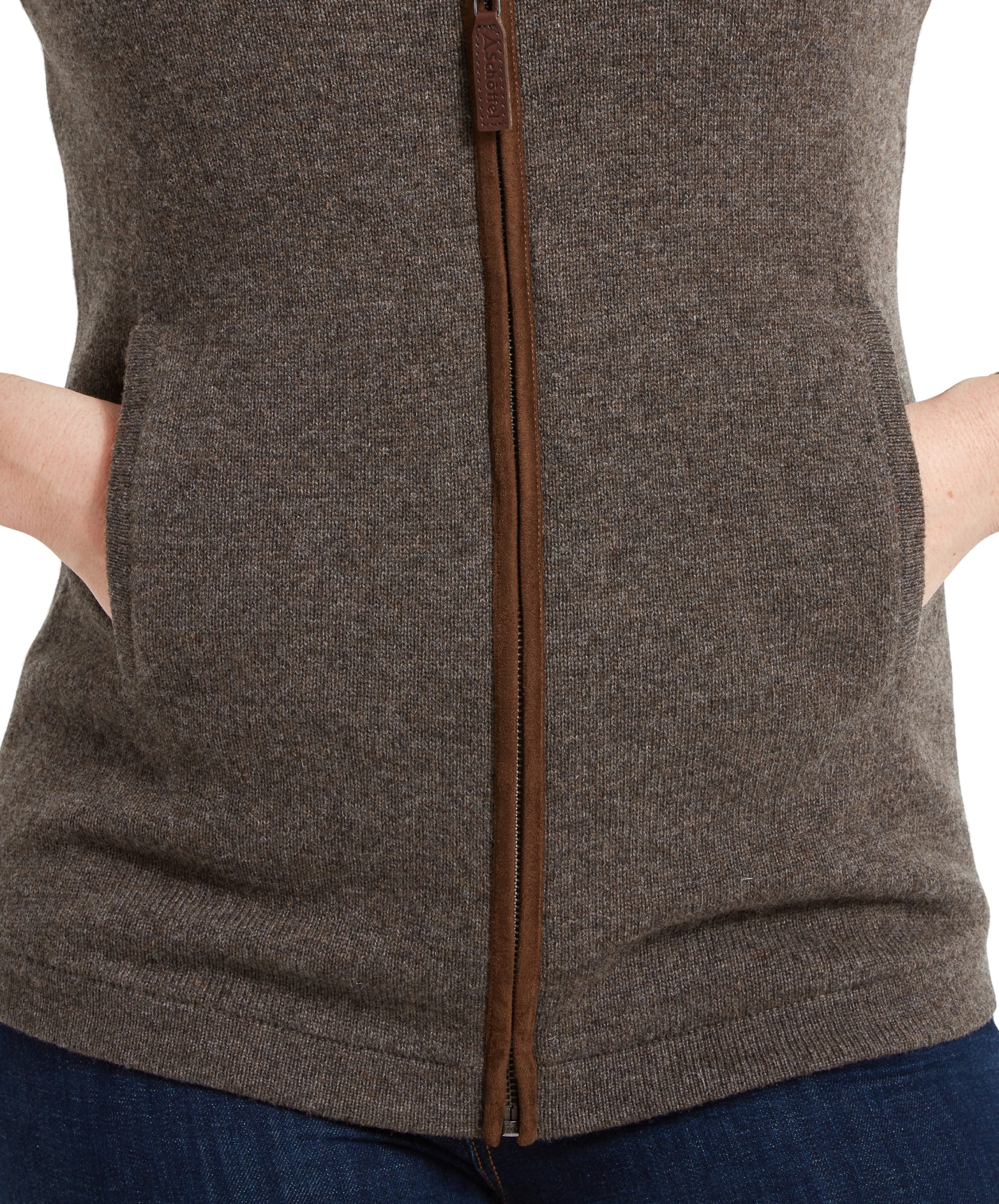 Close-up of the pocket area of the Schöffel Women's Lambswool Aerobloc Gilet for Womens in Brown, showing the hand in the pocket and the fine knit texture of the fabric.