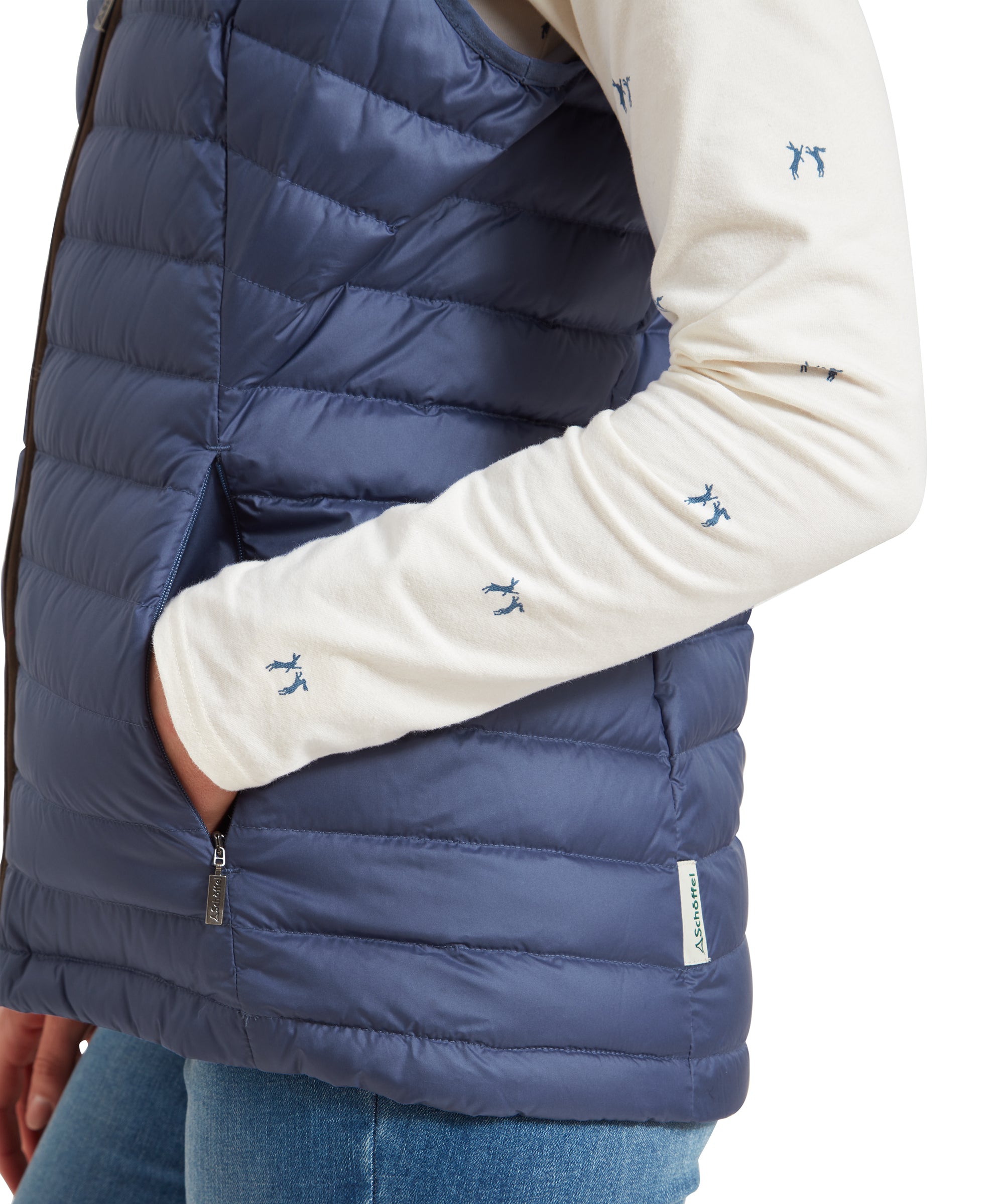 A close-up of the lower half of the Schöffel Launde Down Gilet for Women in Blue highlighting the pocket and ribbed detail on the gilet.