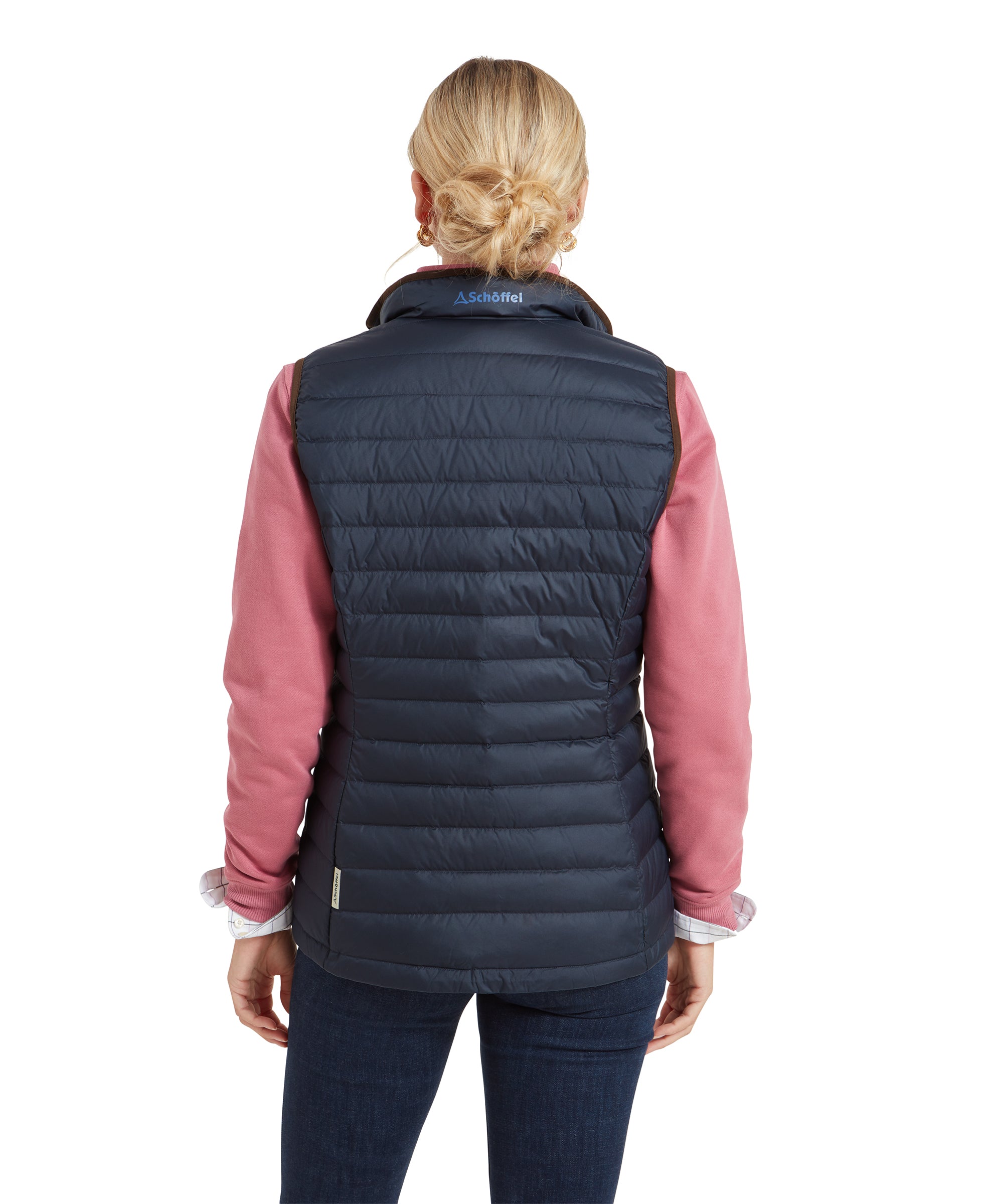 A back view of the woman showing the back design of the Schöffel Launde Down Gilet for Women in Navy, with the Schöffel logo near the collar.