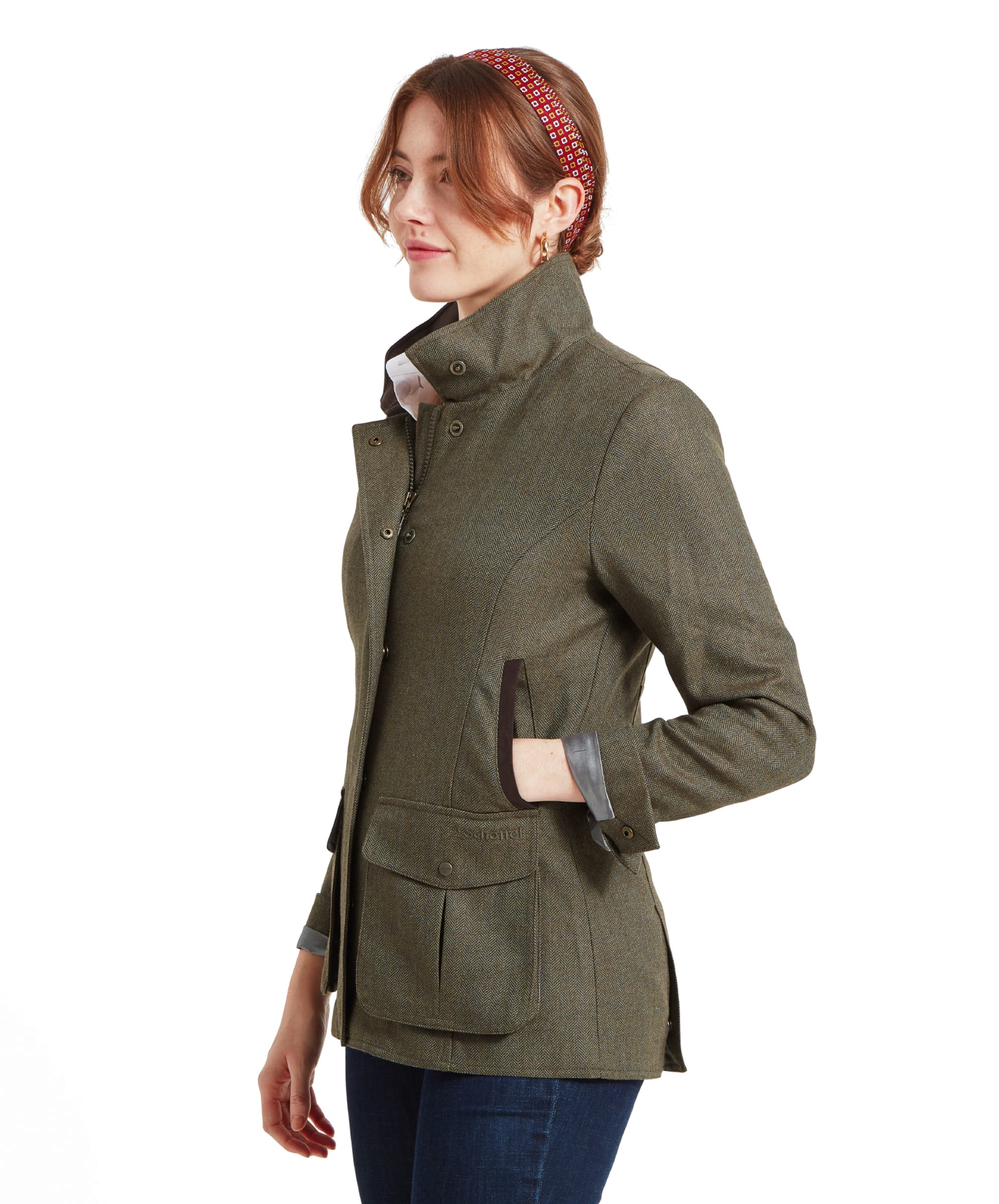 Side profile of the woman in the Schöffel Lilymere Jacket for Women in Green, highlighting the tailored fit and sleek design of the jacket, along with its high collar and dark brown pocket trim.