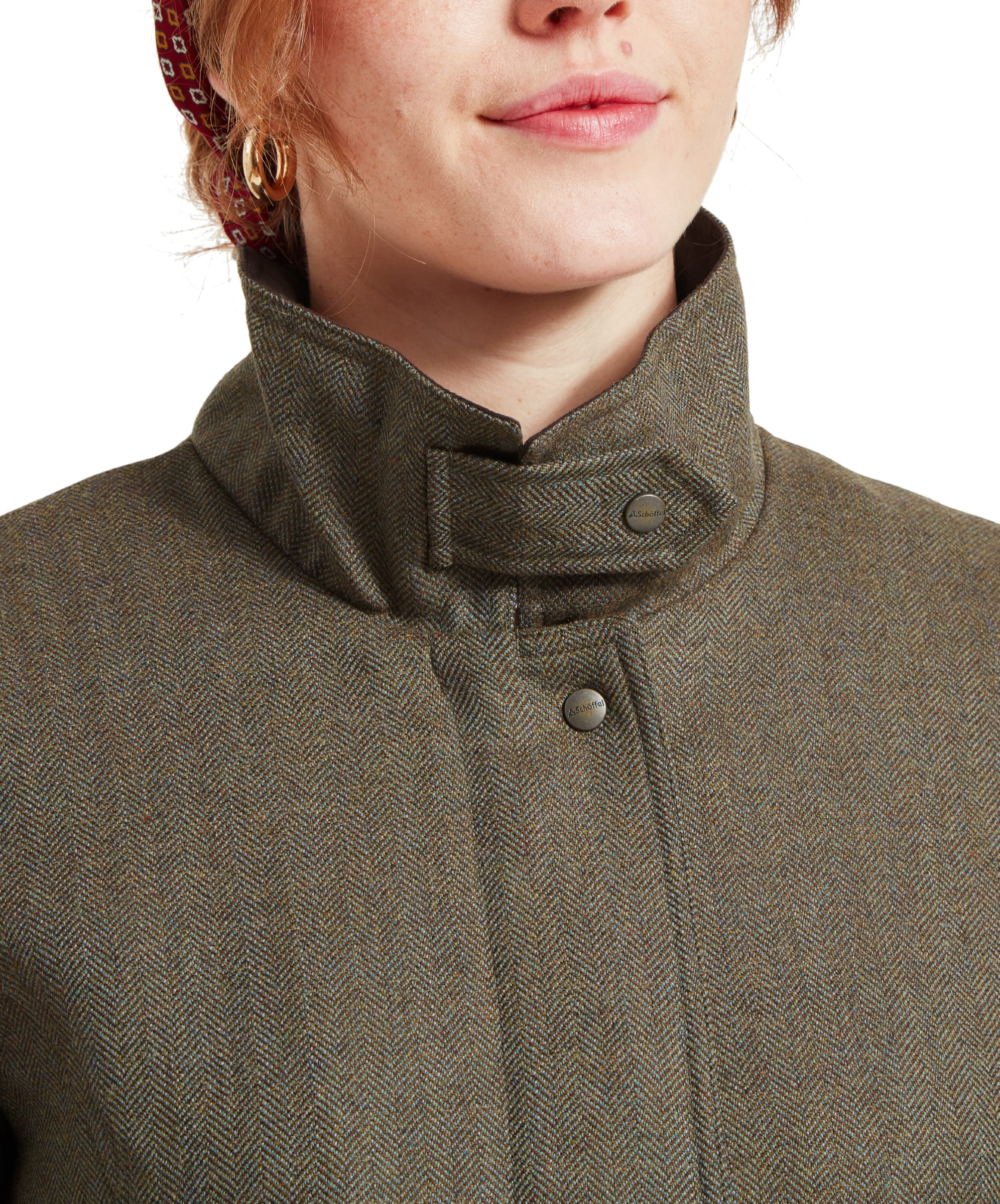 Close-up of the Schöffel Lilymere Jacket for Women in Green's high collar with button closure, emphasising the quality and texture of the tweed fabric.