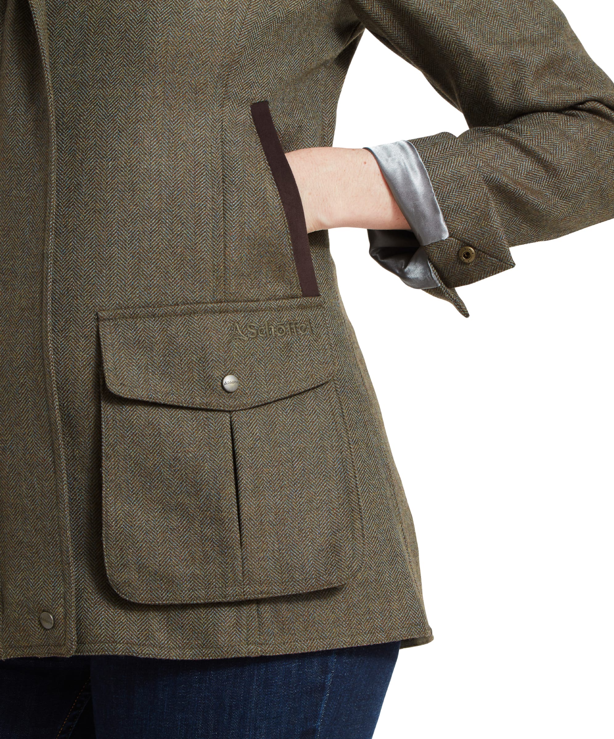 Close-up of the large front pocket on the Schöffel Lilymere Jacket for Women in Green, featuring a flap with a button closure.