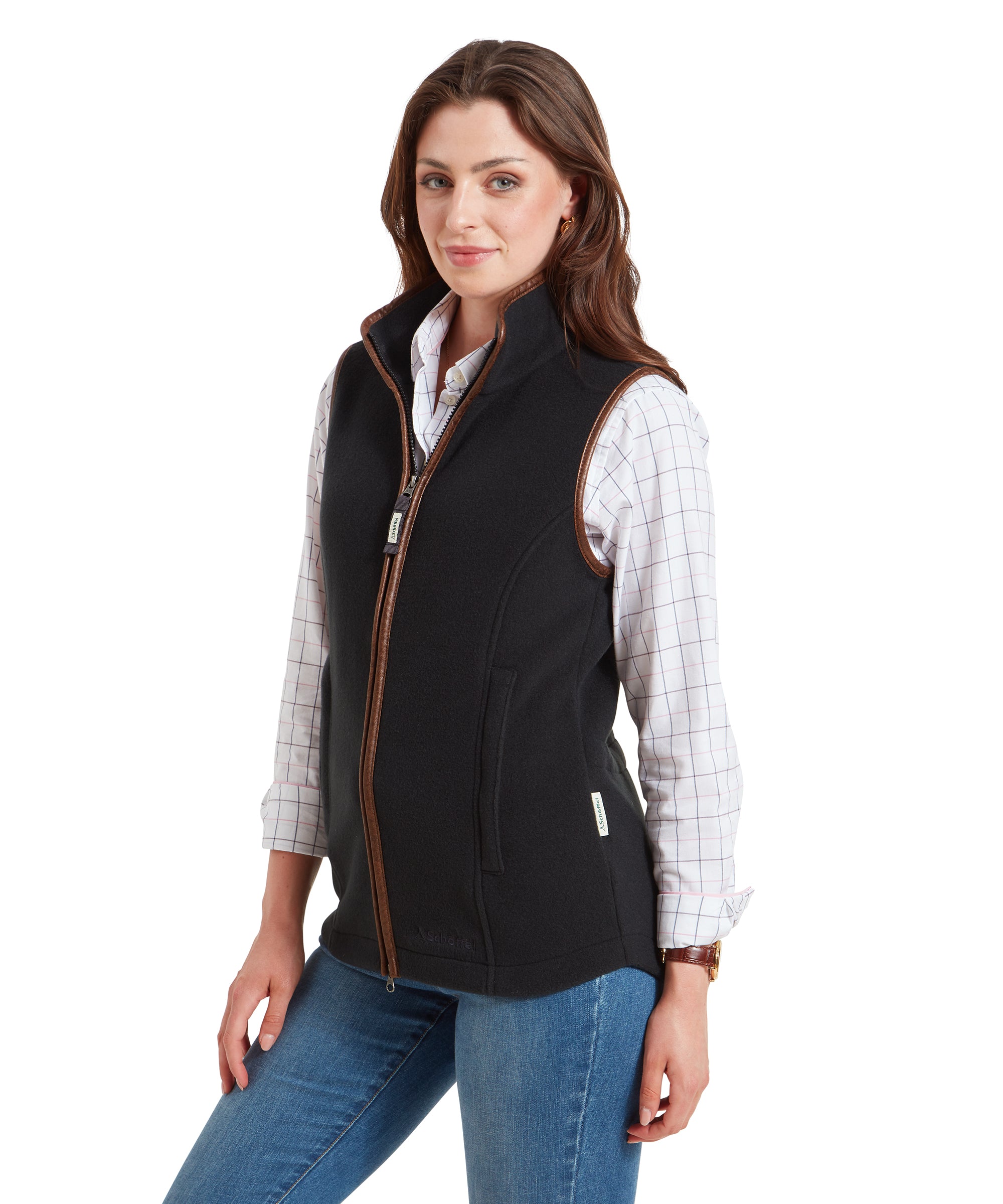 A side view of the woman wearing the Schöffel Lyndon Fleece Gilet for Women in Grey. She is turned slightly to the left, with a subtle smile on her face, showing the profile of the gilet.