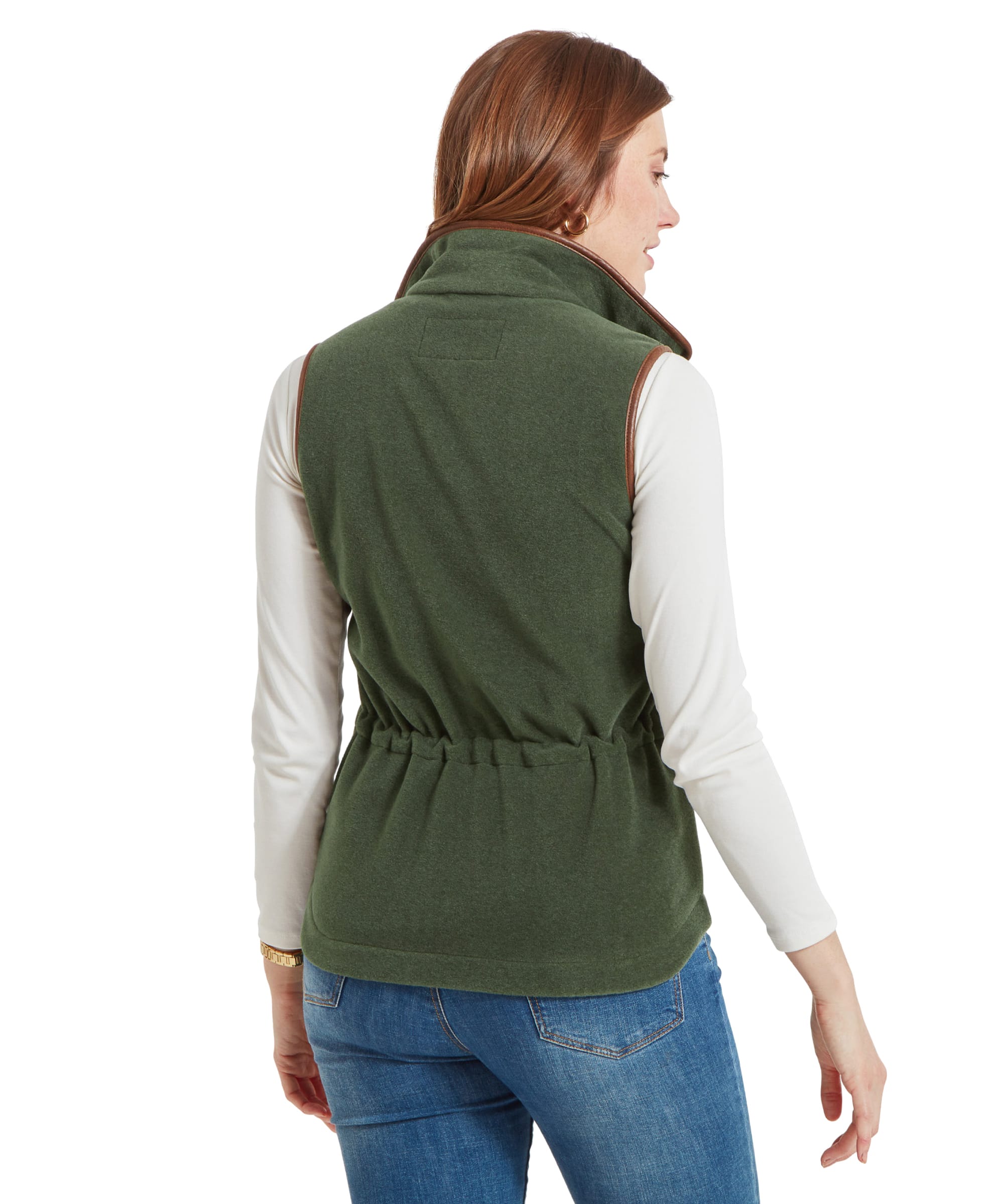 Back view of a woman wearing a Schöffel Lyndon Fleece Gilet for Women in Green, showing the gathered waist detail, over a white turtleneck and blue jeans.