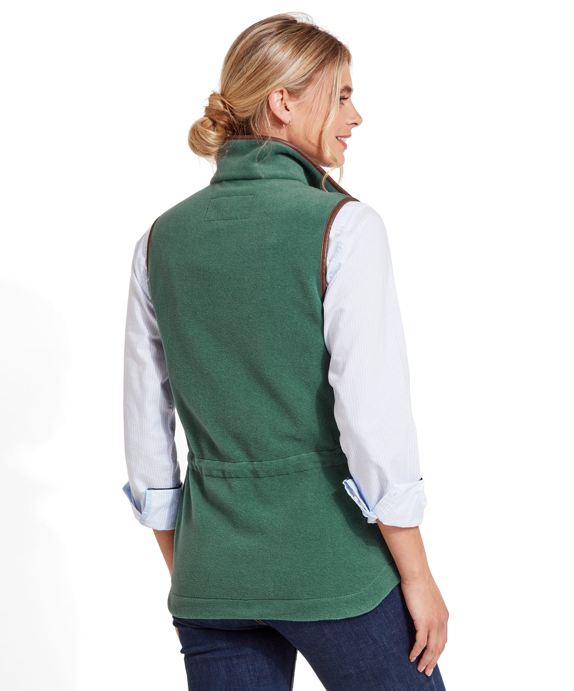 Rear view of the woman showing the back of the Schöffel Lyndon Fleece Gilet for Women in Teal Blue. The gilet has a slight curve at the waist, emphasising a fitted look. The brown trim continues along the shoulders.