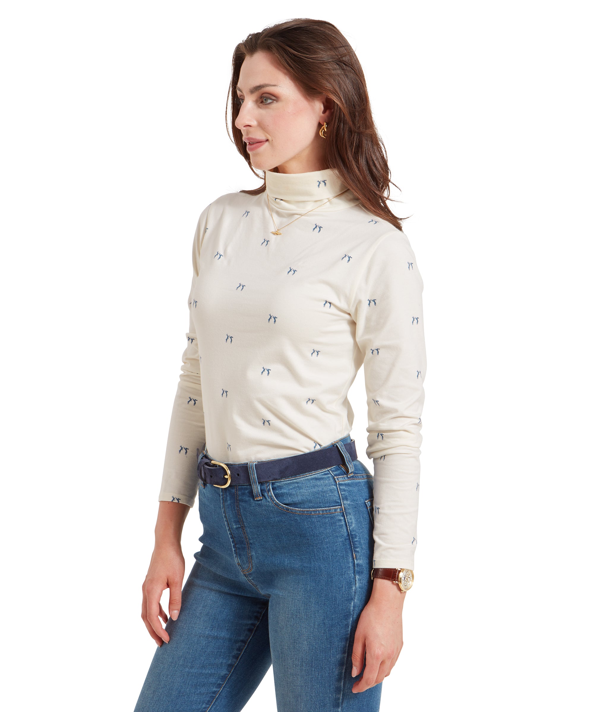 A side profile of the woman in a Schöffel Malham Top for Women in Blue, showing the blue pattern on the fabric, paired with light blue jeans and a navy belt.