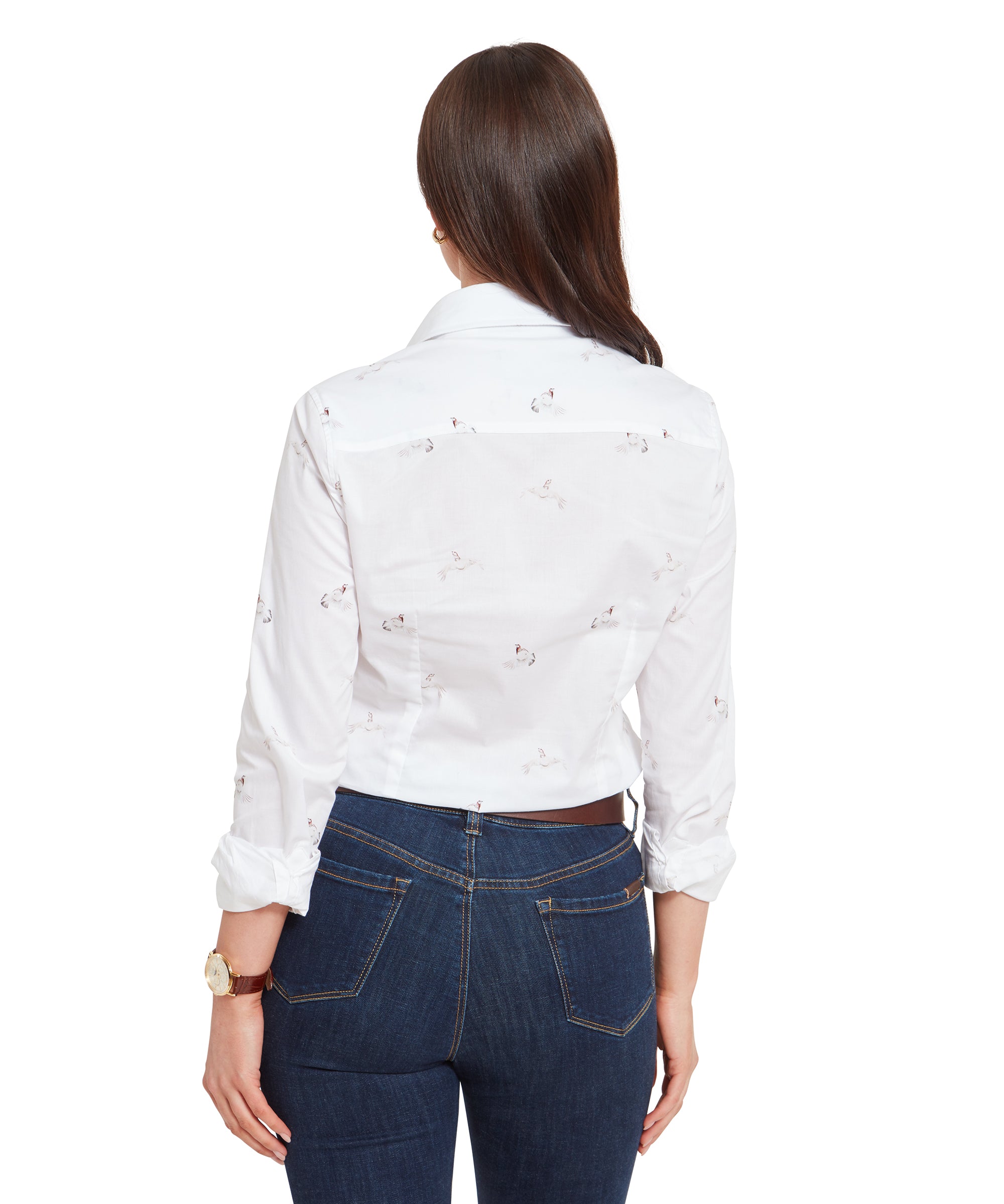 A rear view of the woman wearing the Schöffel Norfolk Shirt for Womens in White Grey with pheasant print, highlighting the back of the shirt and her long dark brown hair, which falls naturally over her back. The shirt is neatly tucked into her dark blue jeans.