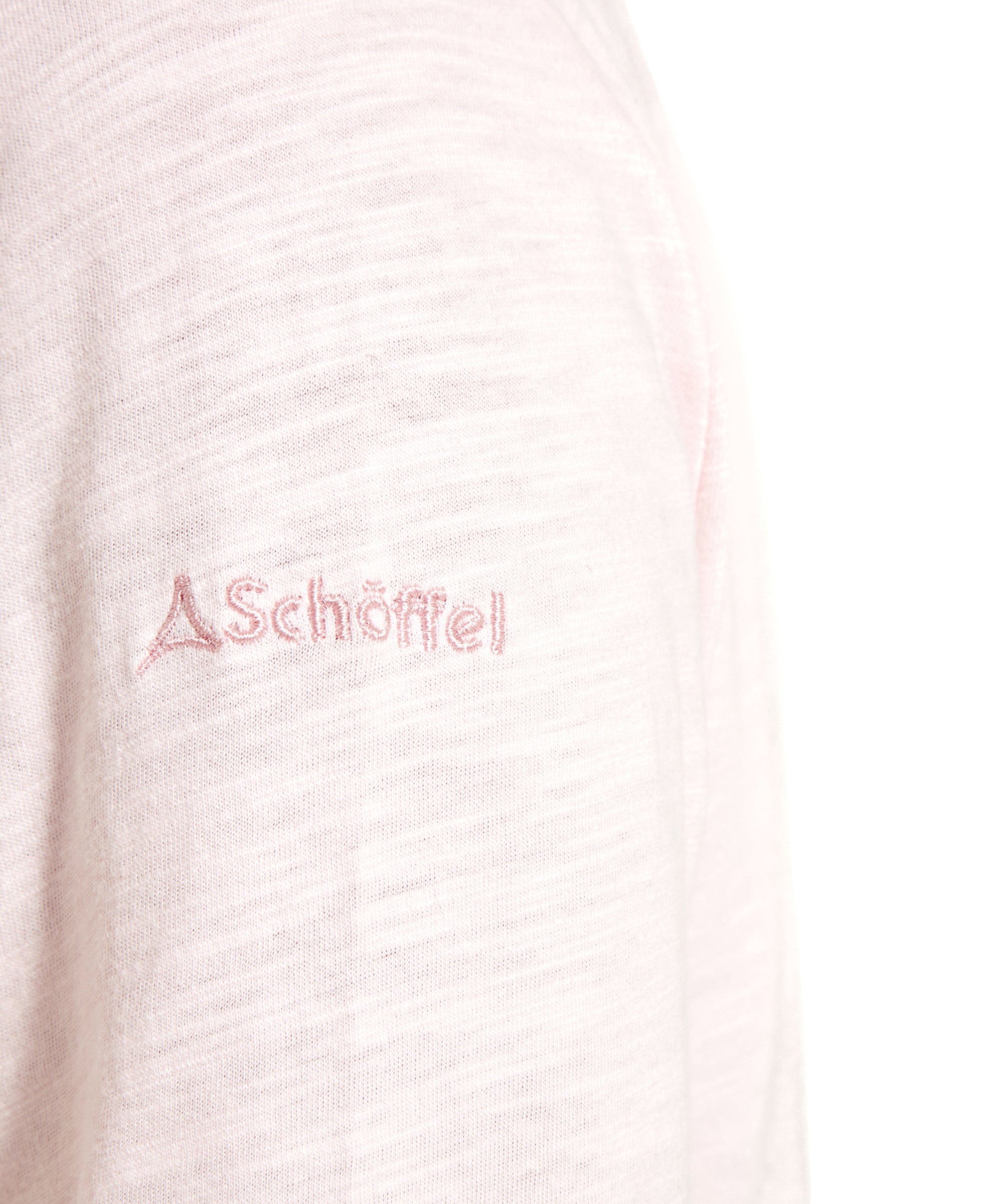 Close-up of the sleeve of the Schöffel Pentle Bay Top for Women in Pink, featuring the embroidered "Schöffel" logo in matching pink thread.