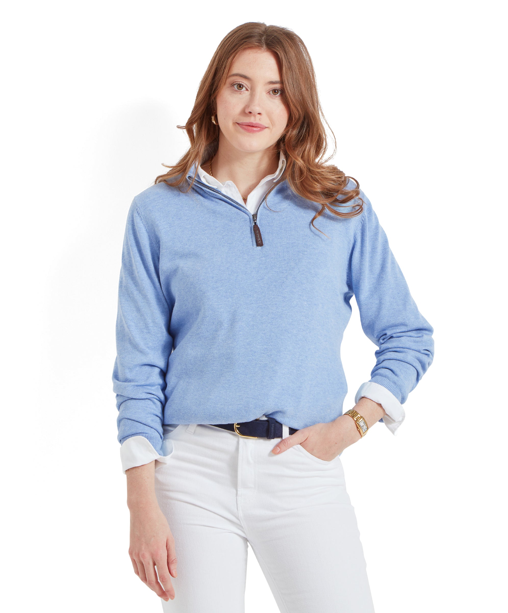 Woman wearing a Schöffel Polperro Pima Cotton 1/4 Zip for Women in Blue and white jeans, hands in pockets, smiling slightly.