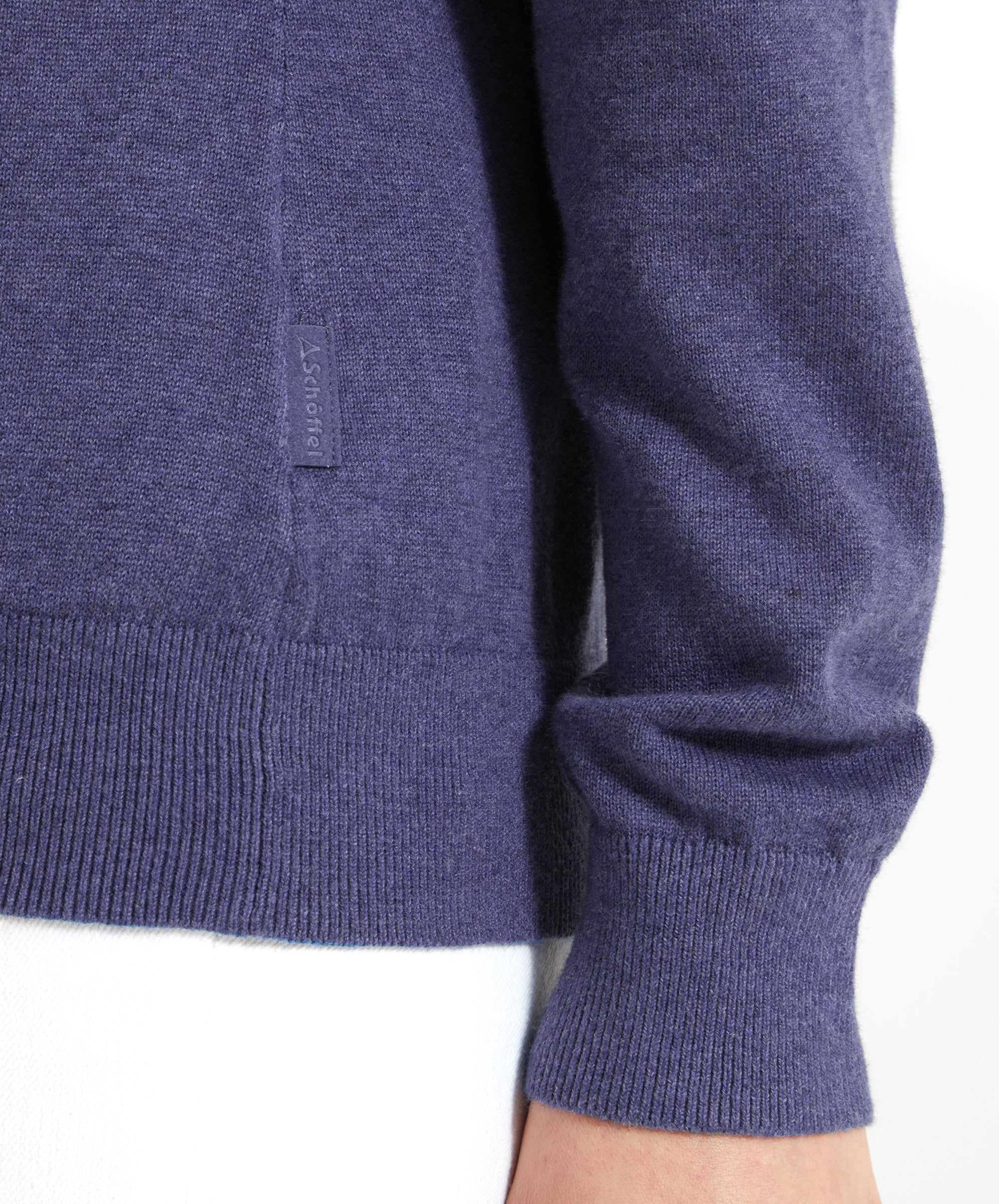 Close-up of the hem and cuff of a Schöffel Polperro Pima Cotton 1/4 Zip for Women in Navy Blue with a visible Schöffel tag.