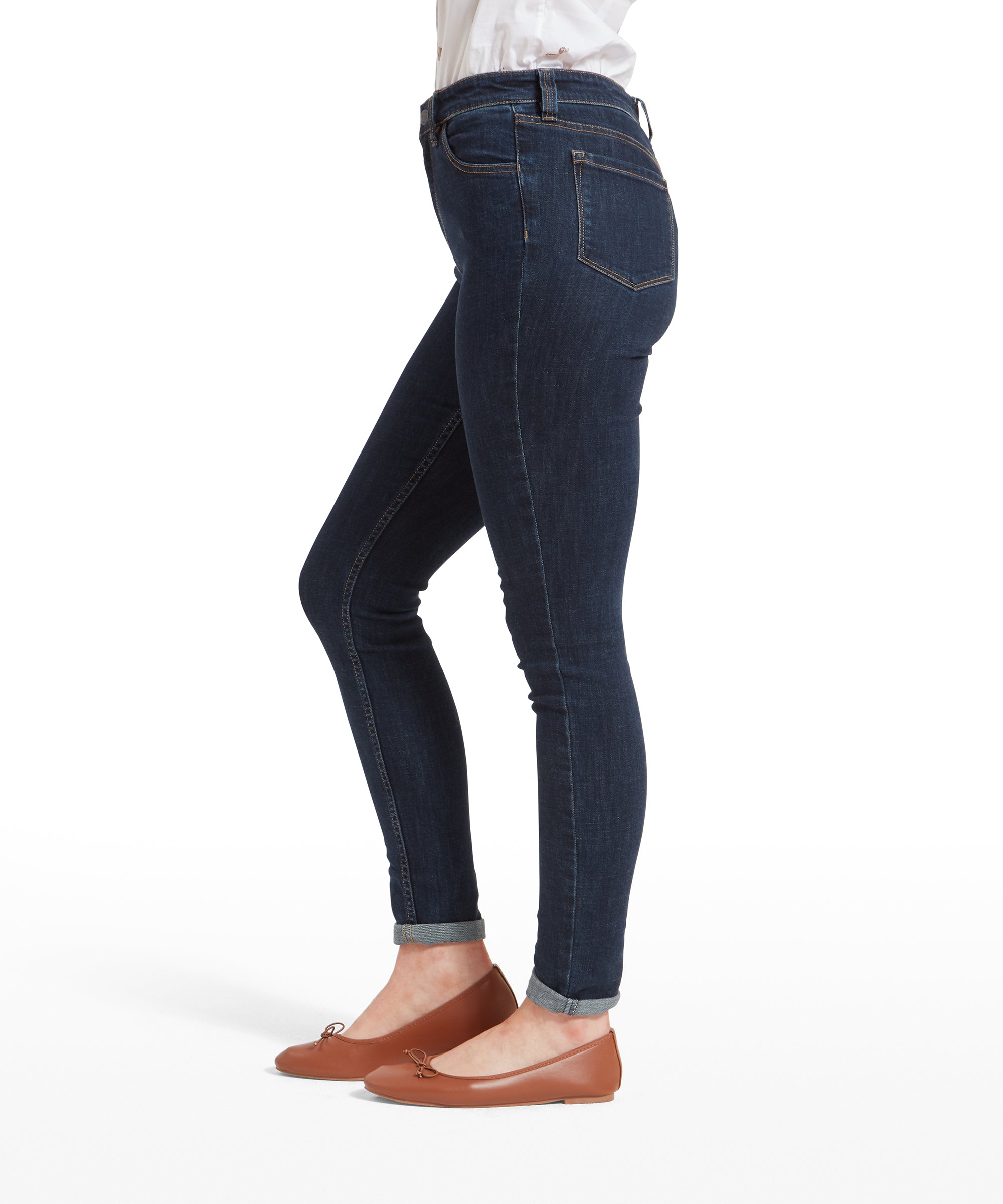 Side view of the woman showing the Schöffel Poppy Jean for Womens in Dark Blue, with her shirt neatly tucked in. The jeans fit closely along her leg, emphasising a streamlined silhouette.