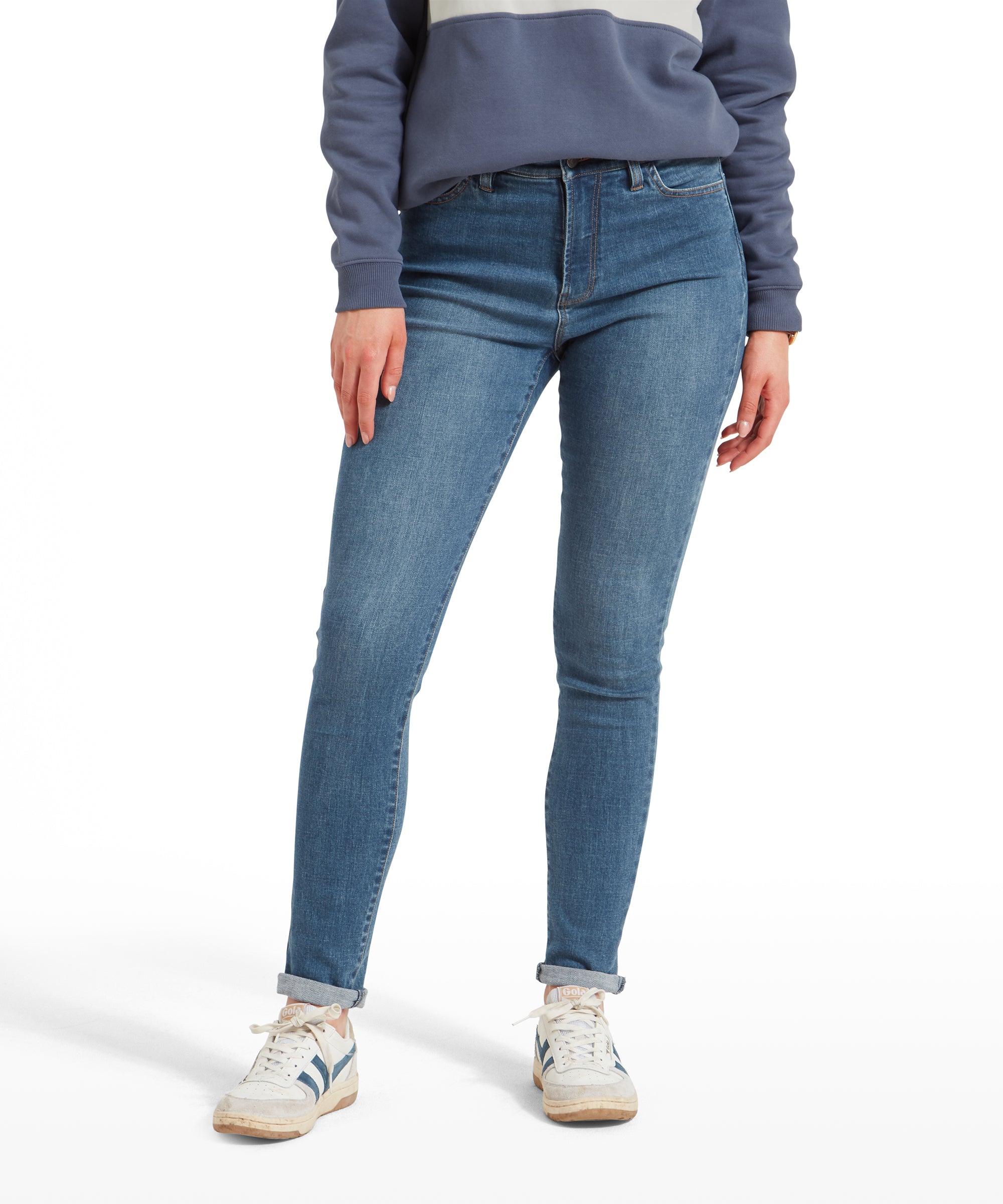 Front view of a woman wearing Schöffel Poppy Jean for Womens in Blue, a blue and white striped sweatshirt, and white trainers.