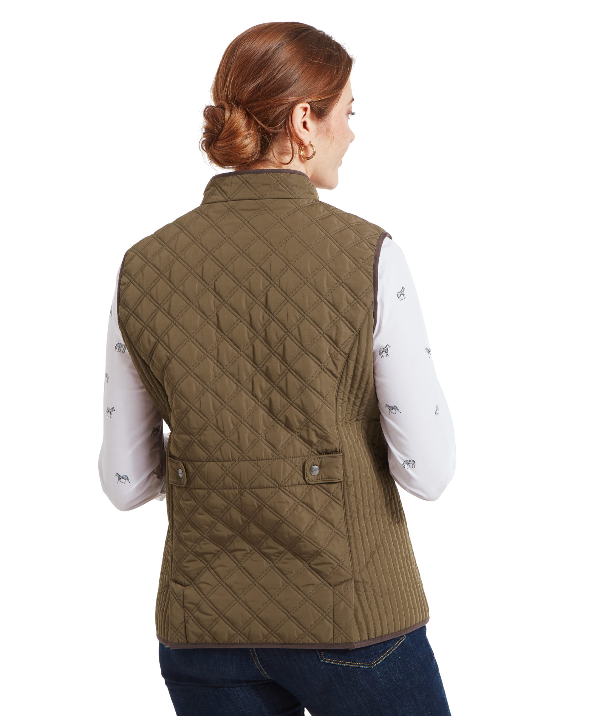 Back view of a woman wearing a Schöffel Quilt Gilet for Women in Green, showing the diamond quilt pattern and waist adjustment tabs.