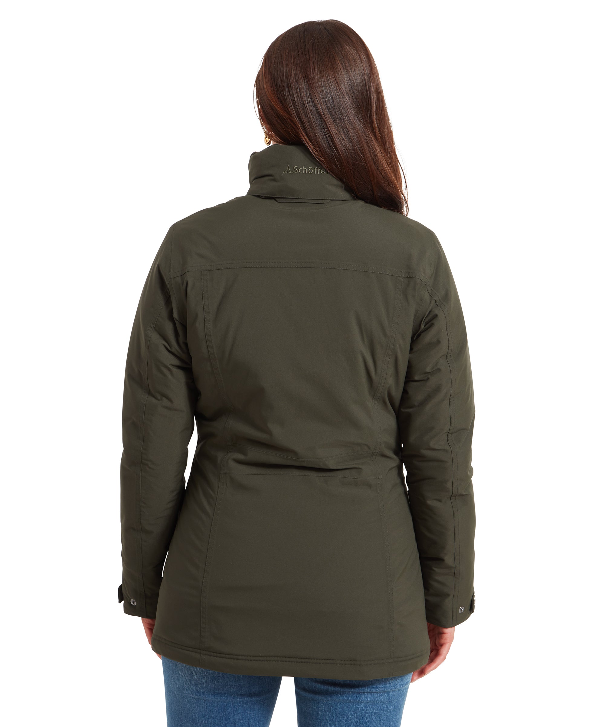 Back view of the woman in the Schöffel Rockingham II Coat for Women in Green, showing the back details and the coat's length just below the hips.