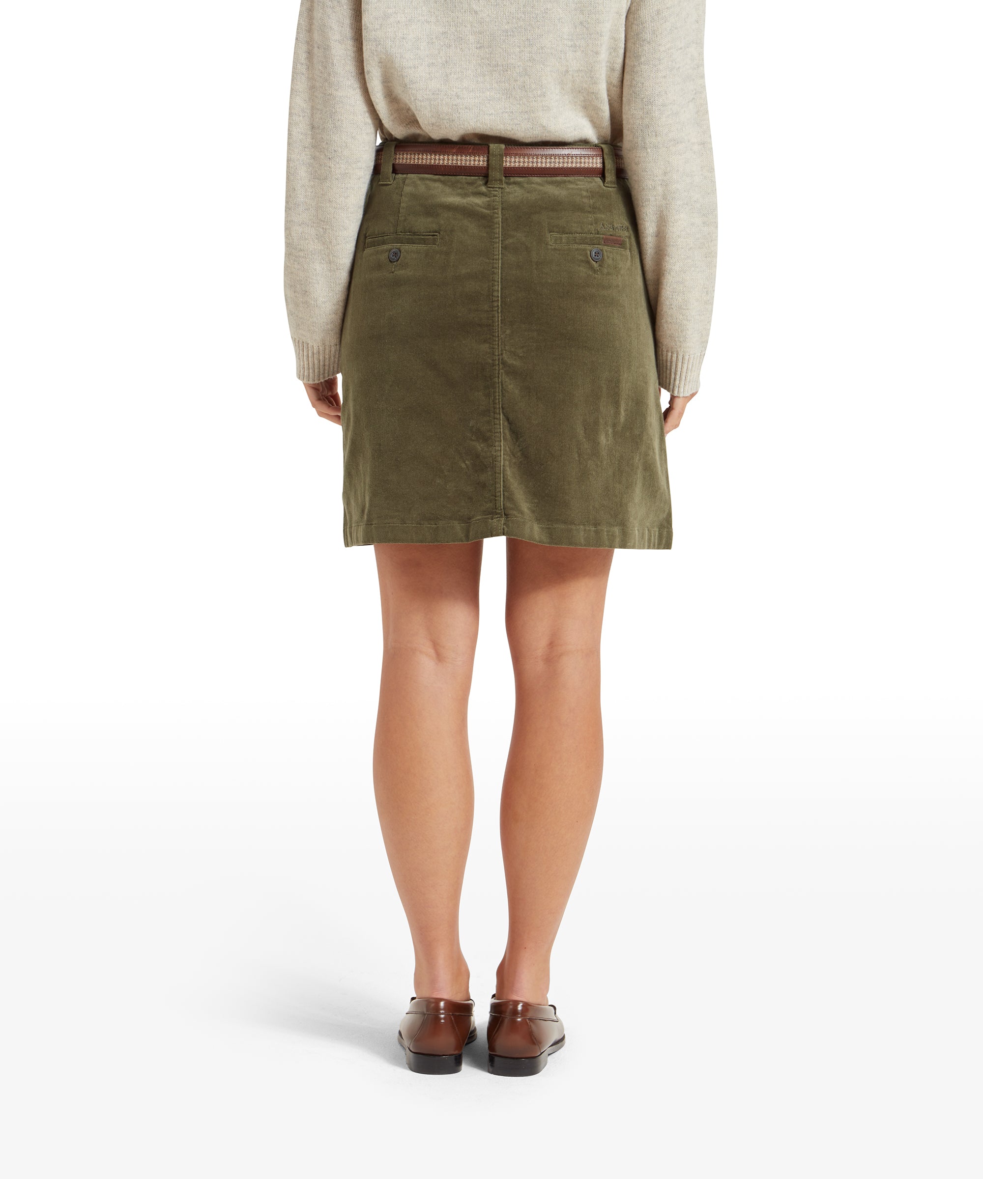 Back view of the Schöffel Sage Cord Skirt for Women in Green. The skirt has two back pockets with button closures, and the woman is wearing a brown belt. The image shows the texture and fit from behind.