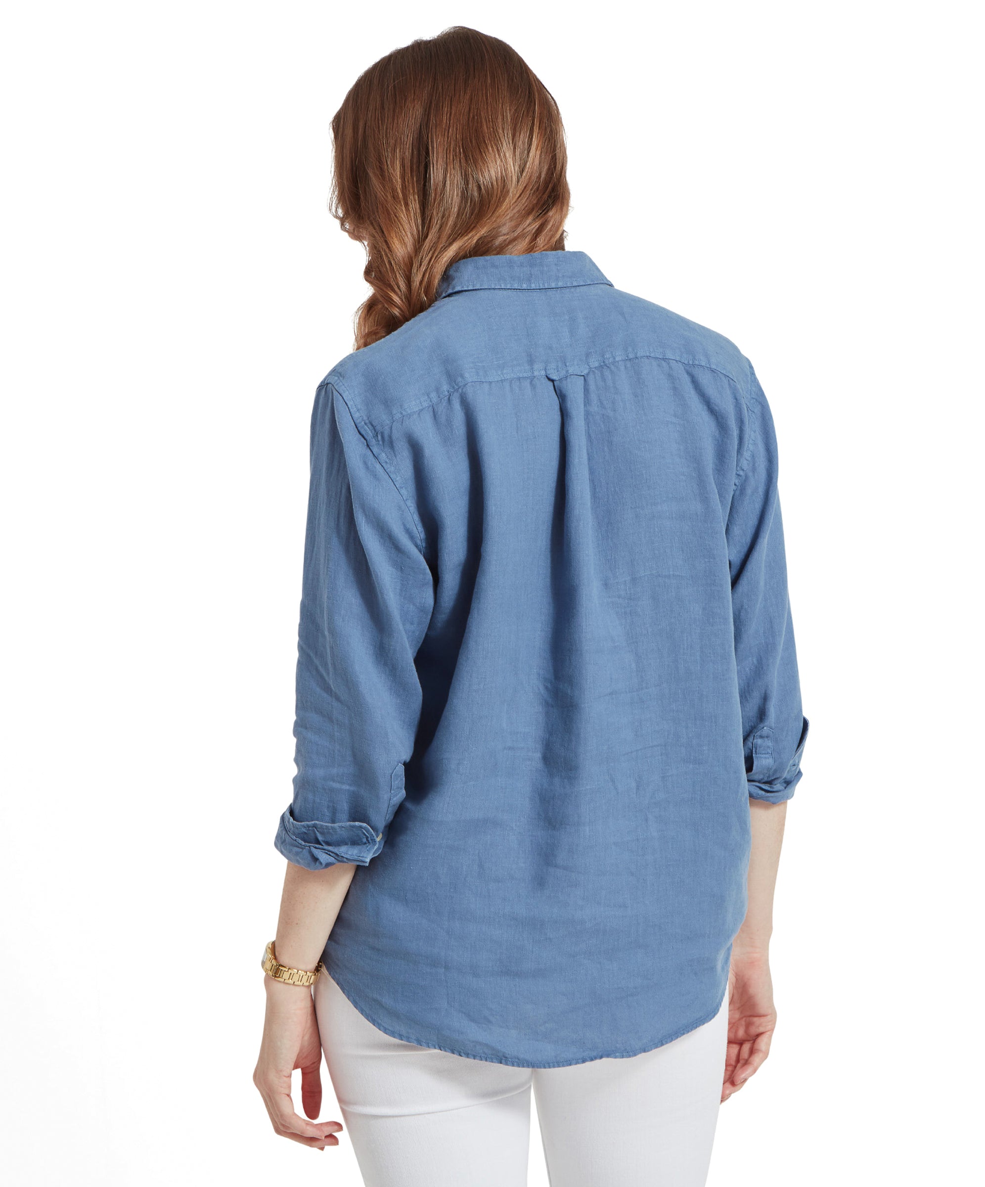 Rear view of the woman, showing the back of her Schöffel Salthouse Linen Shirt for Women in Blue.