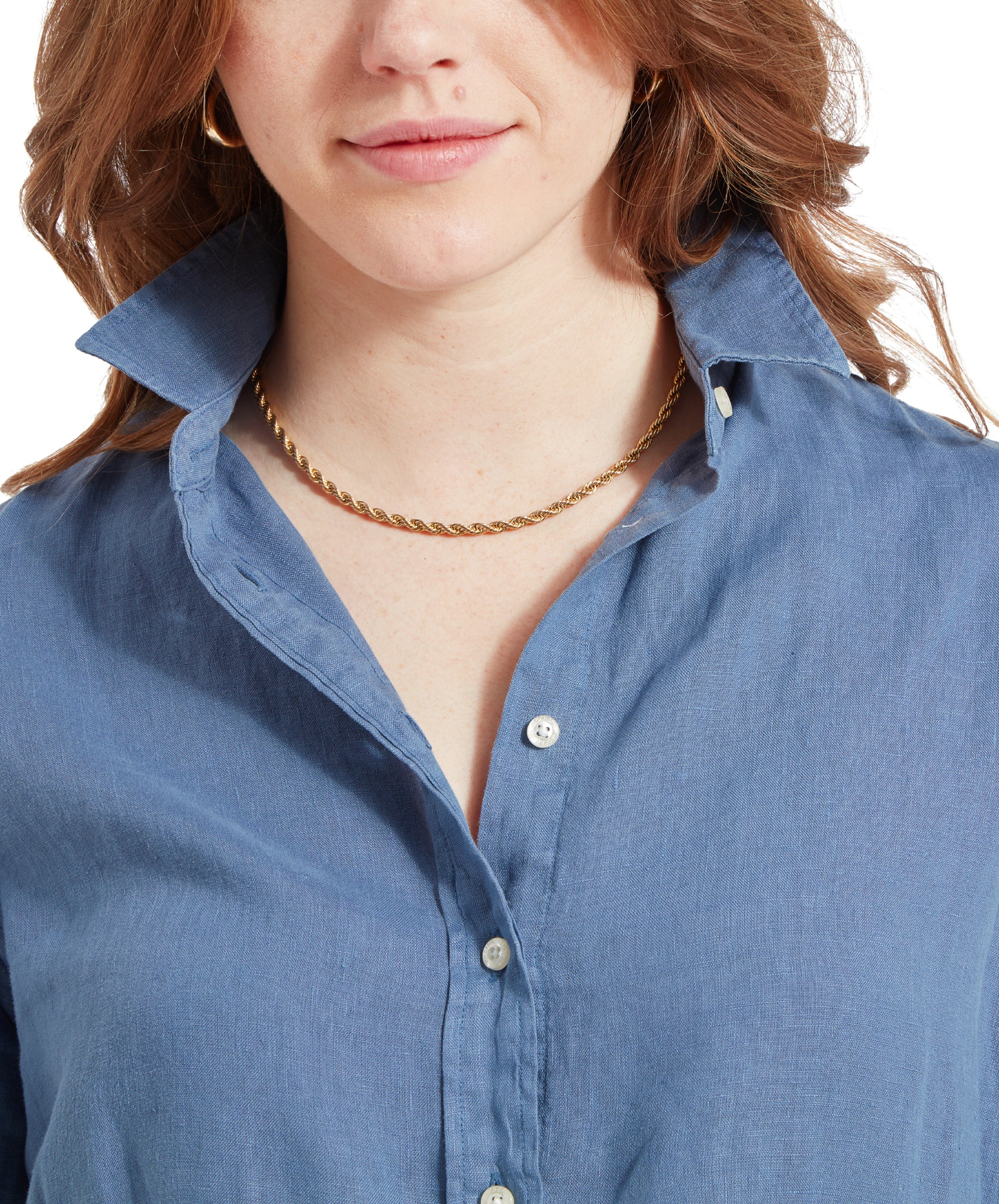 Close-up of the woman's collar and gold necklace, showing the details of her Schöffel Salthouse Linen Shirt for Women in Blue.