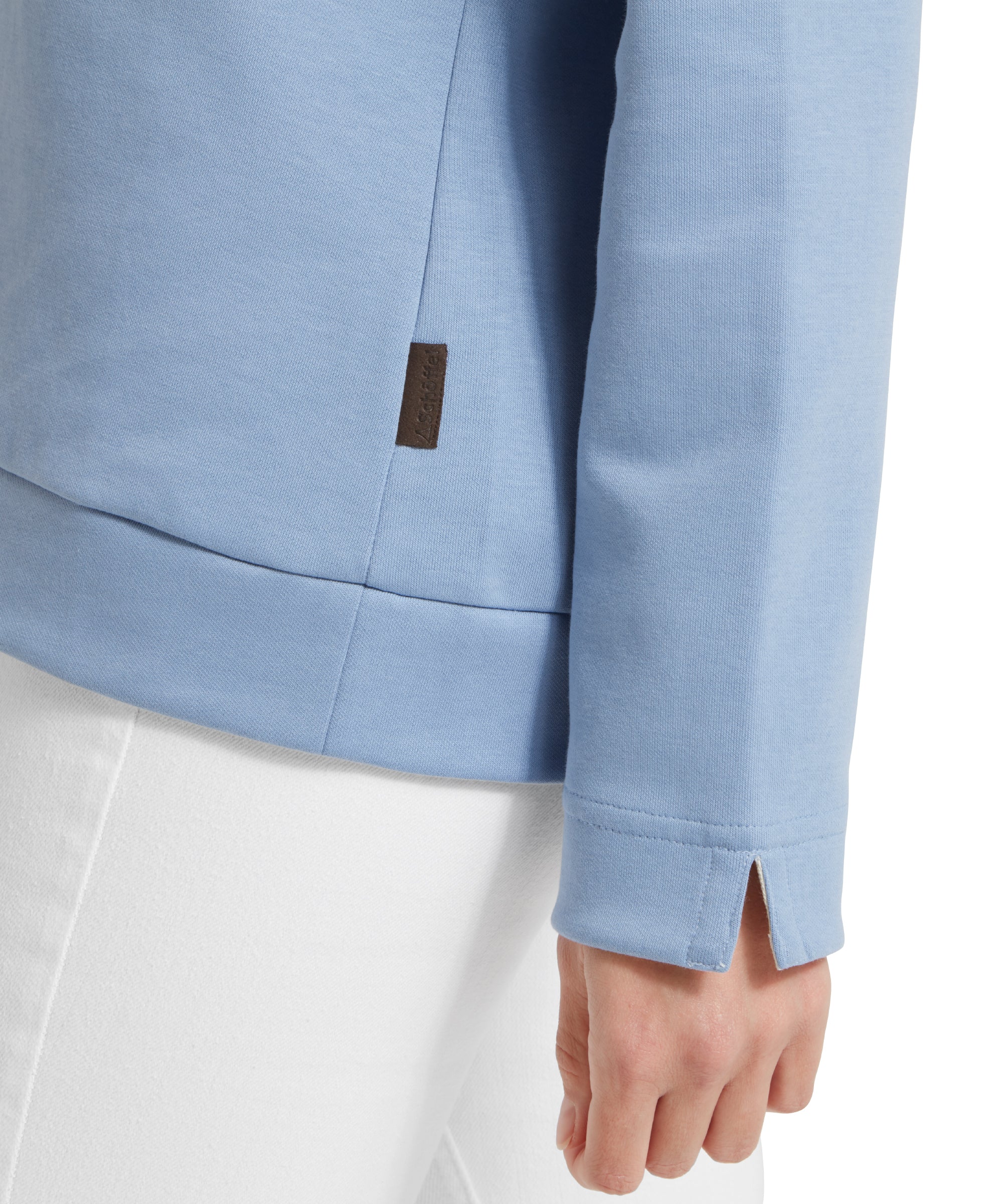 Close-up of sweatshirt cuff of a light blue Schöffel sweatshirt.