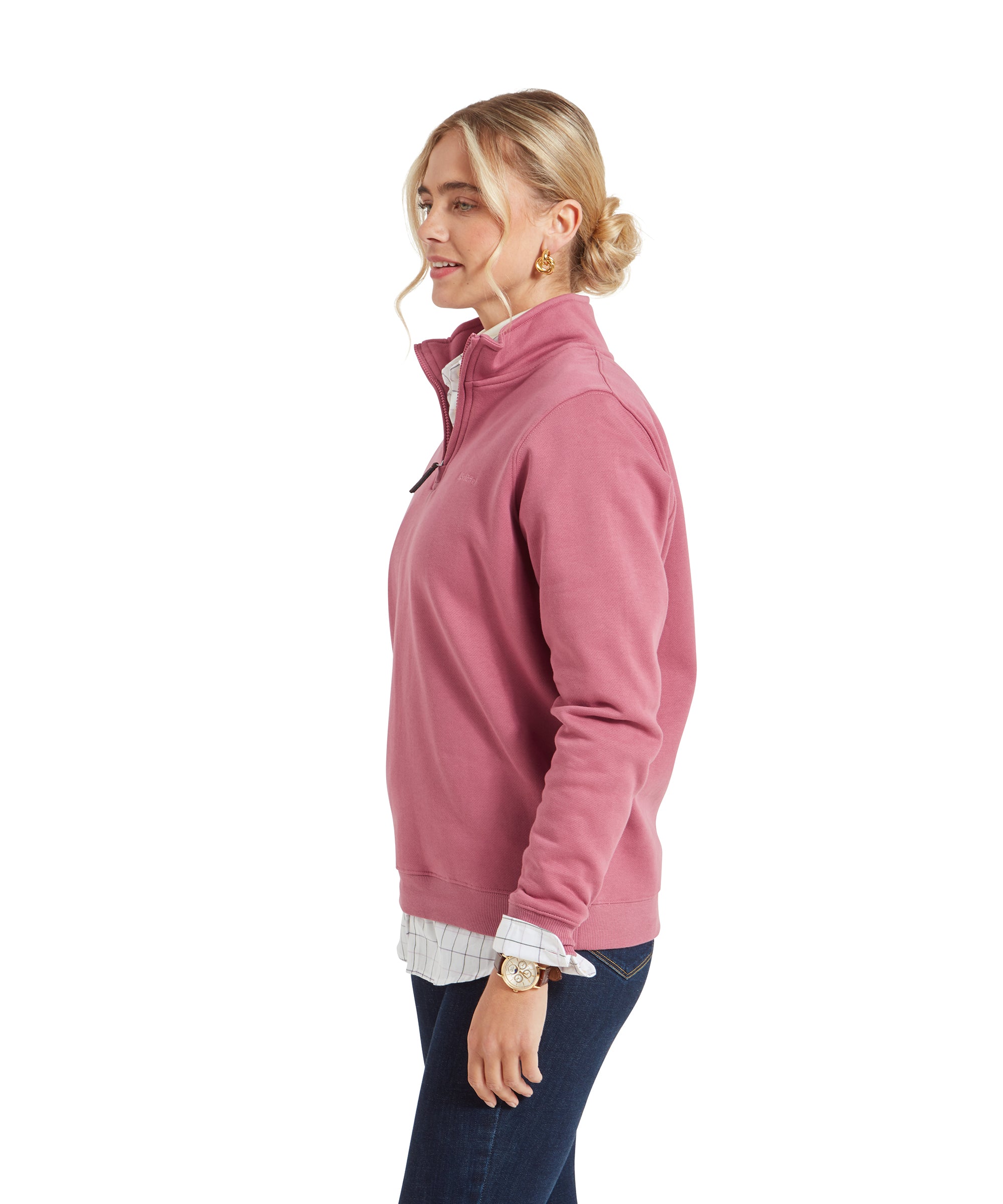 Side profile of the woman in the Schöffel Sennen Cove Sweatshirt for Womens in Pink, with her hair tied in a low bun, showcasing the fit of the sweatshirt from the side.