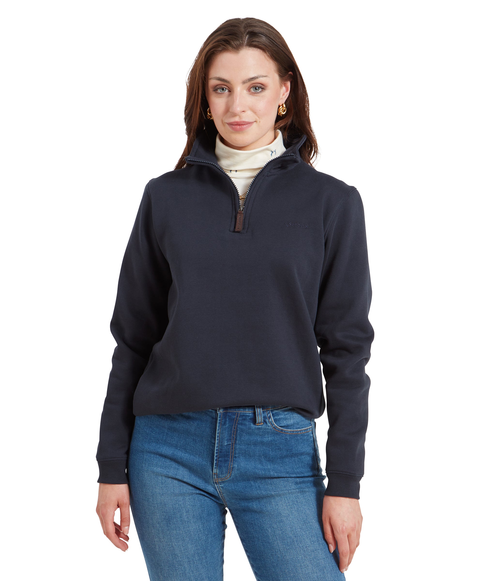 Woman wearing a Schöffel Sennen Cove Sweatshirt for Womens in Dark Blue with a white turtleneck underneath, standing with a slight smile and hands relaxed.