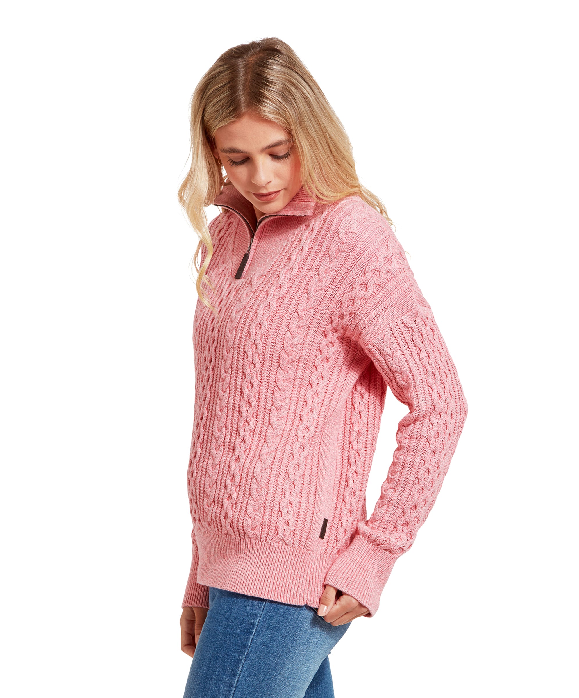 A side view of the woman wearing the Schöffel Settle 1/4 Zip for Women in Pink. She is looking down, and the detailed texture of the sweater is visible, highlighting the intricate knit pattern and the quarter zip feature.