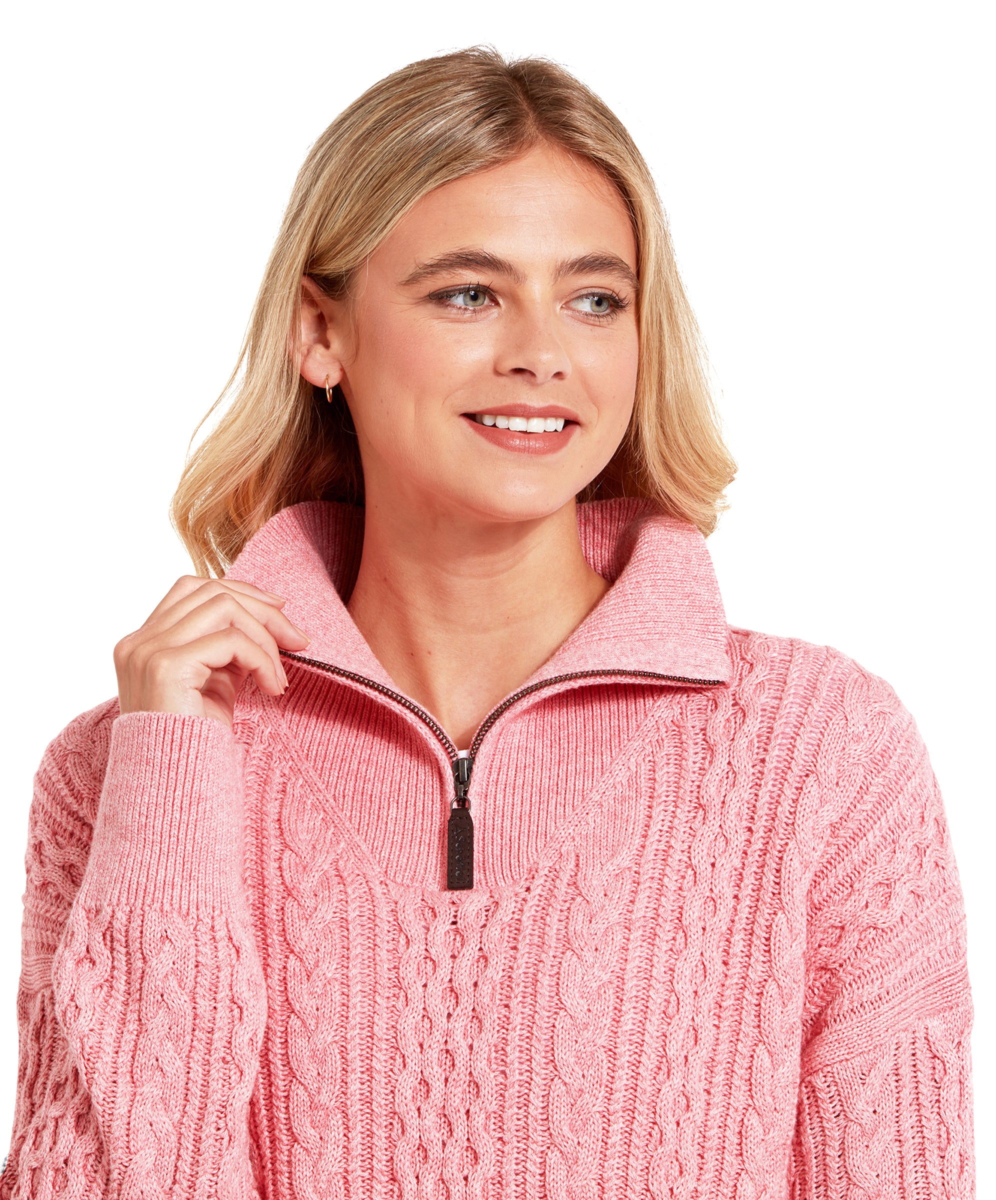 A close-up of the woman's upper body, focusing on the collar and zipper of the Schöffel Settle 1/4 Zip for Women in Pink. She is smiling slightly and has one hand gently pulling at the collar, giving a clear view of the sweater's texture and design details.