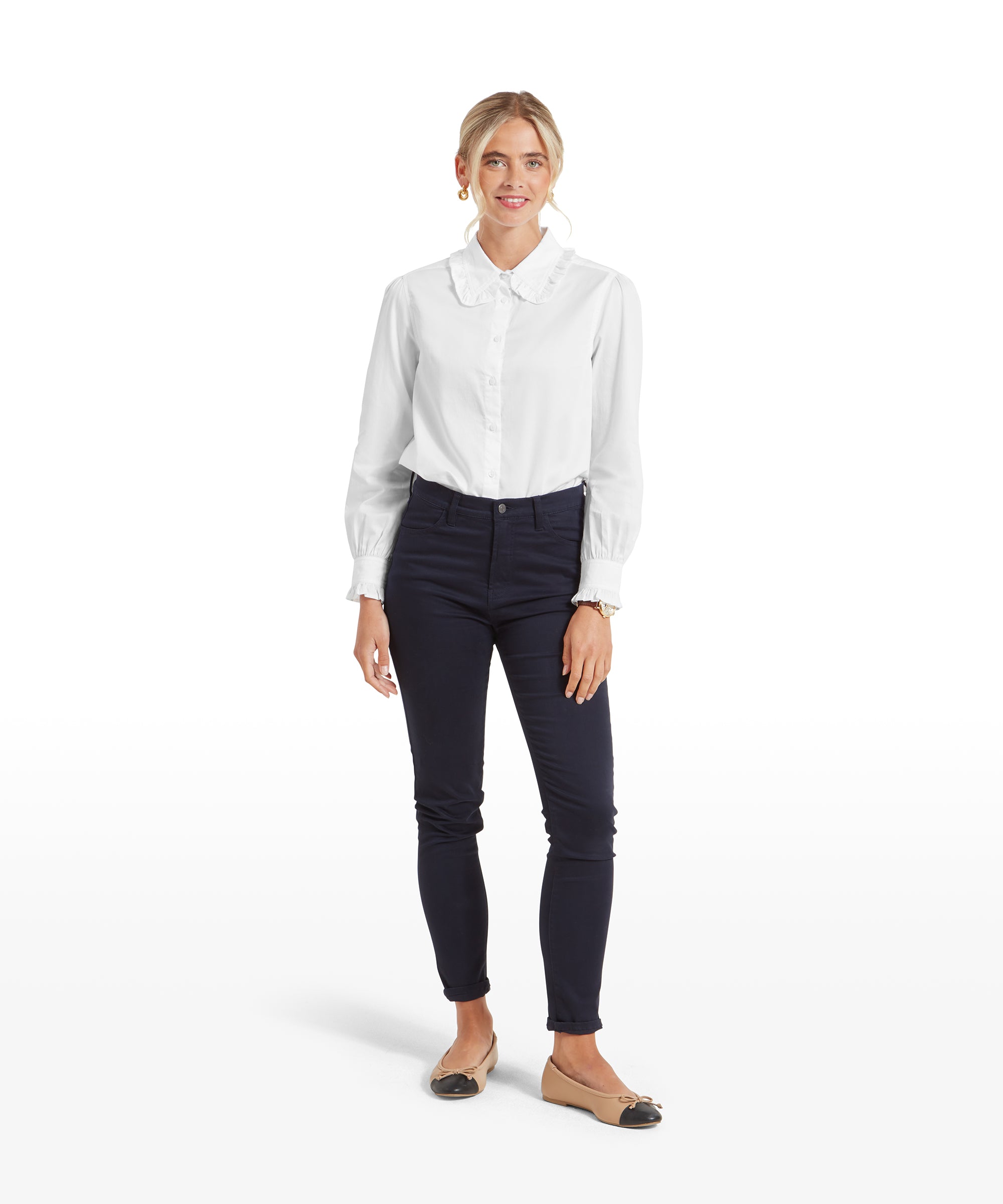 This image is similar to the second one, showing the Schöffel Somerleyton Shirt for Women in White from a distance. The woman’s relaxed stance and confident expression are prominent.