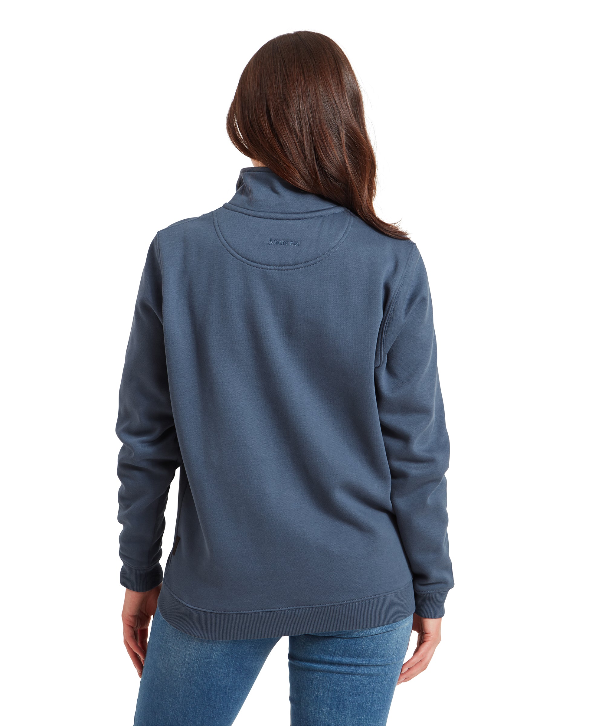 A back view of the woman wearing the Schöffel St Agnus Sweatshirt for Women in Navy, showing the collar and back stitching details. Her hair is down, and the back design is minimal with the Schöffel logo embroidered near the collar.