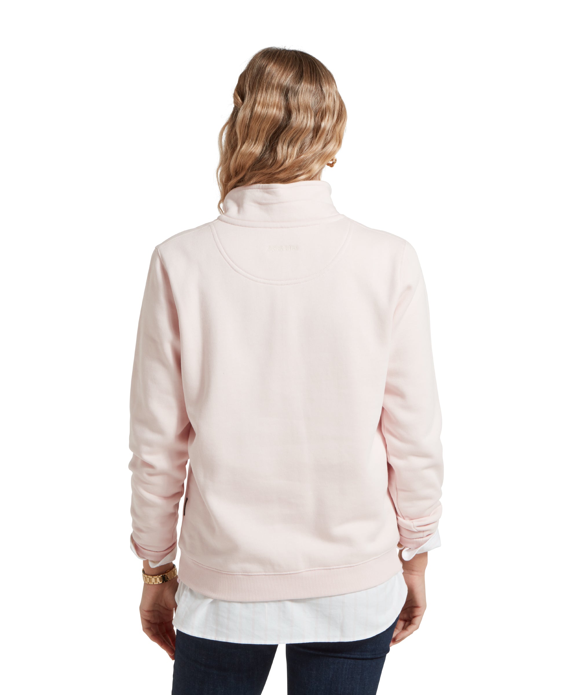 A back view of a woman wearing a Schöffel St Issey Sweatshirt for Women in Light Pink with dark blue jeans and white shirt.