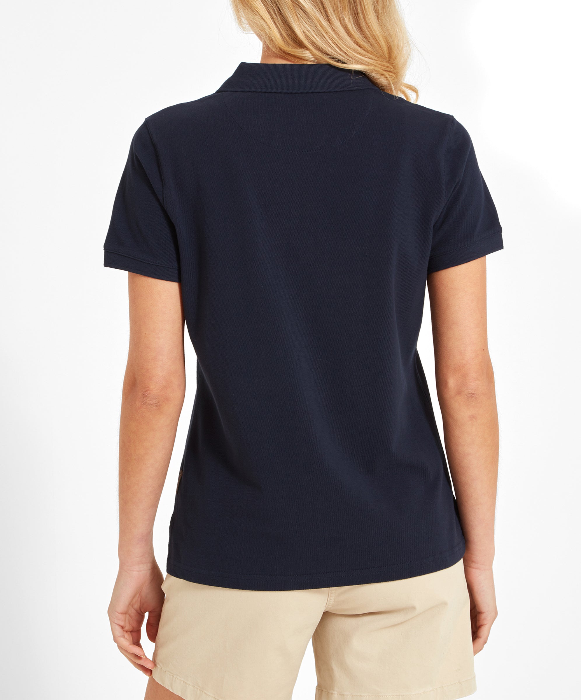 Back view of the woman in the Schöffel Women's St Ives Polo Shirt for Women in Navy, showing the back design of the shirt.