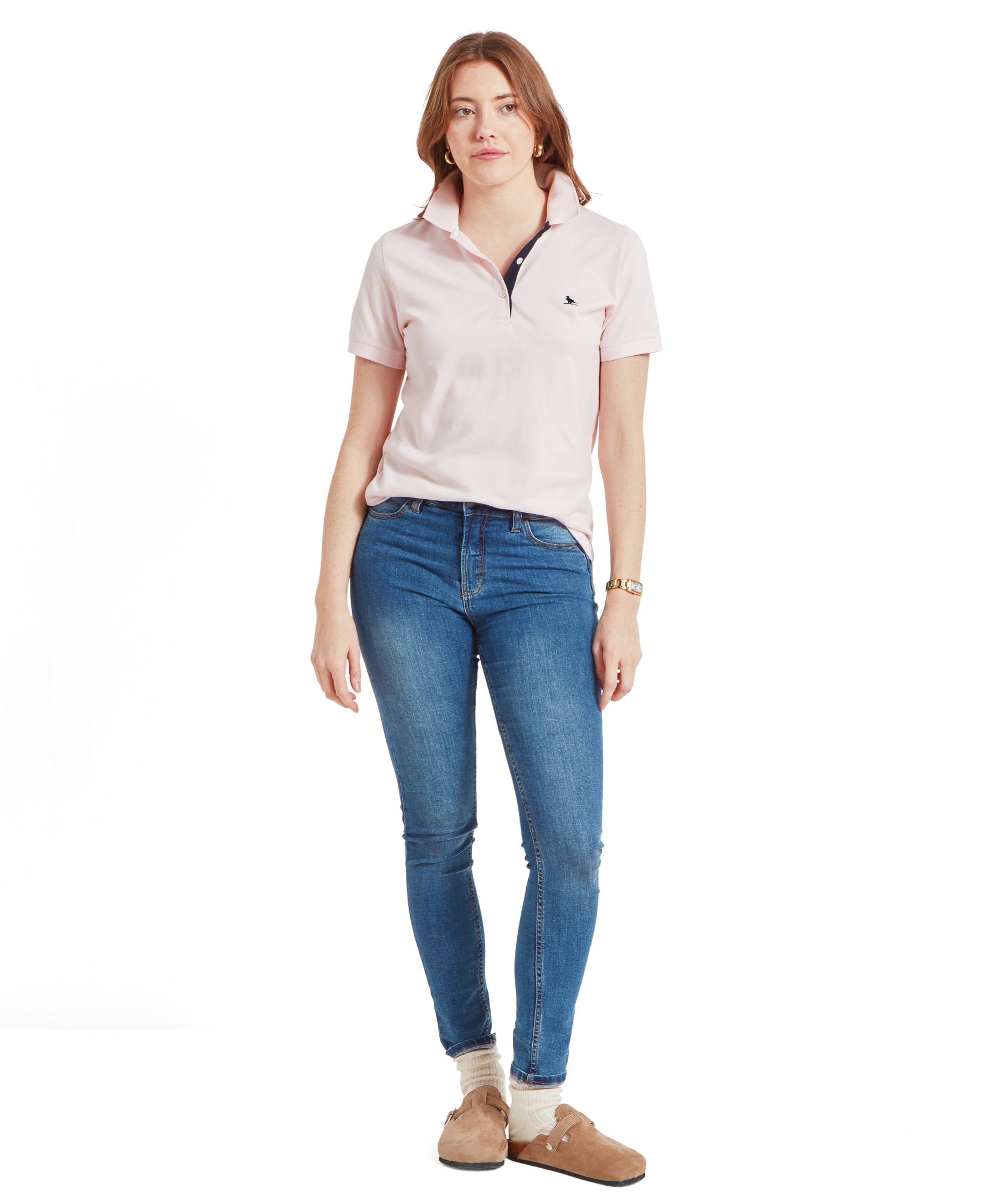 Full view of the woman in a Schöffel Women's St Ives Polo Shirt for Women in Pale Pink and jeans.