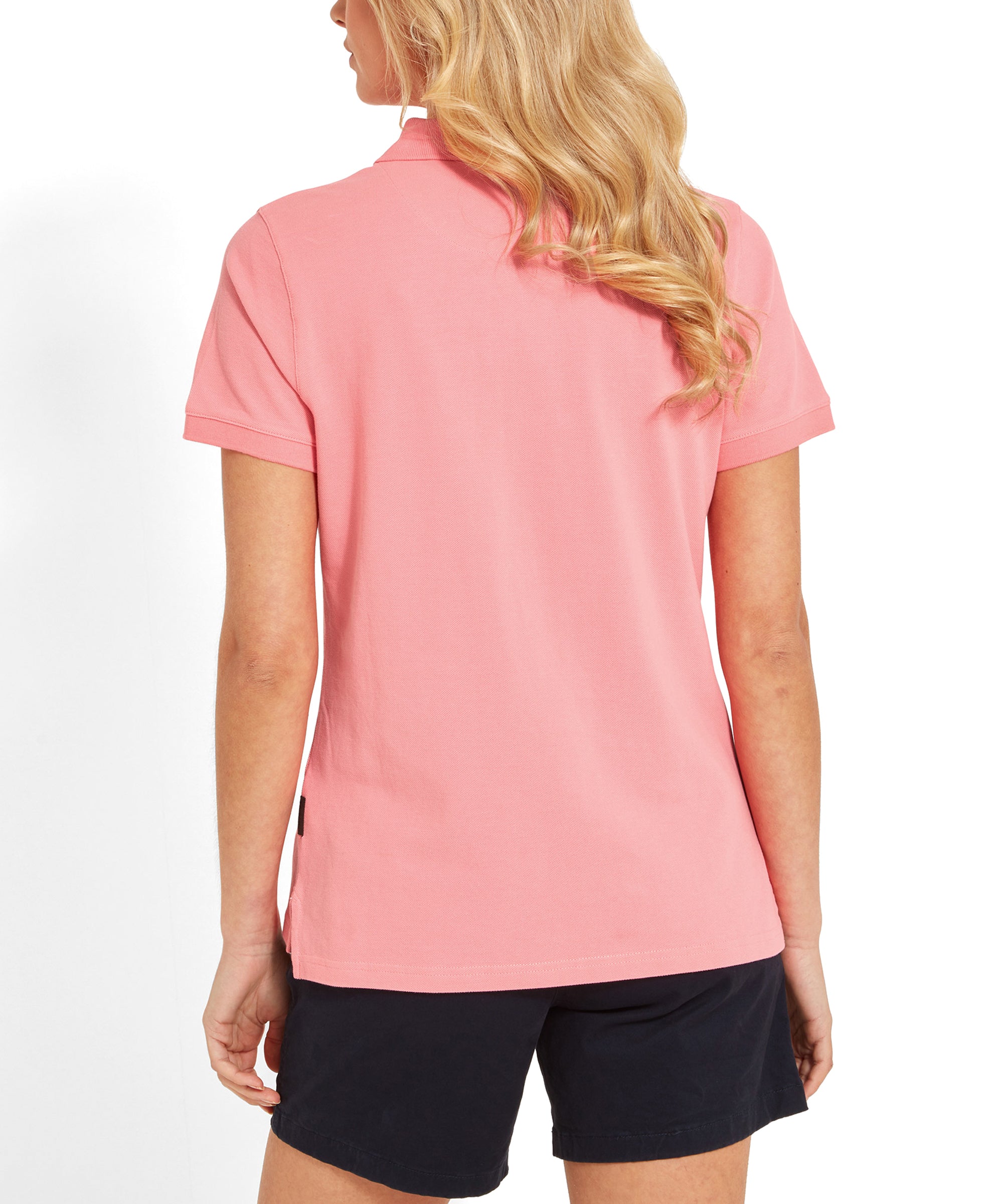 Back view of the Schöffel Women's St Ives Polo Shirt for Women in Pink. The models hair in gentle waves.